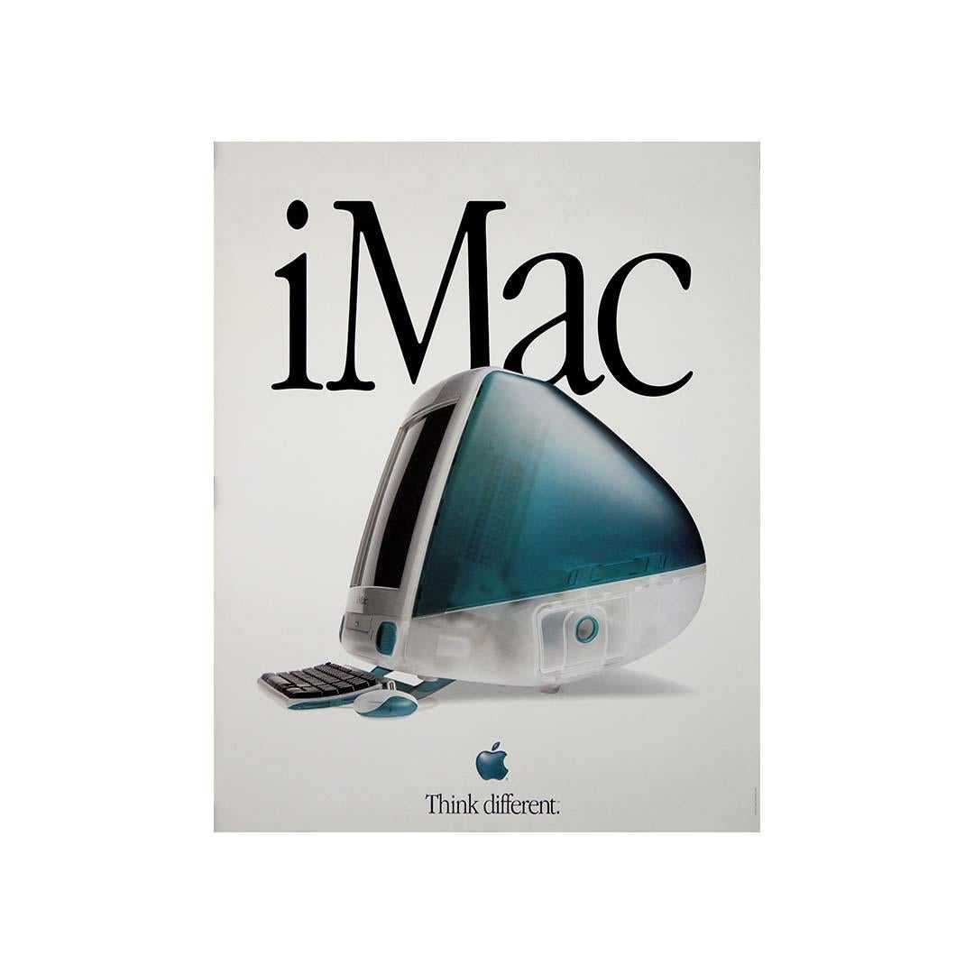 This original 1998 Apple advertising poster celebrates the revolutionary debut of the iMac G3, a computer that redefined design and consumer technology at the turn of the century. Dominated by the word “iMac” in elegant black serif typography, the