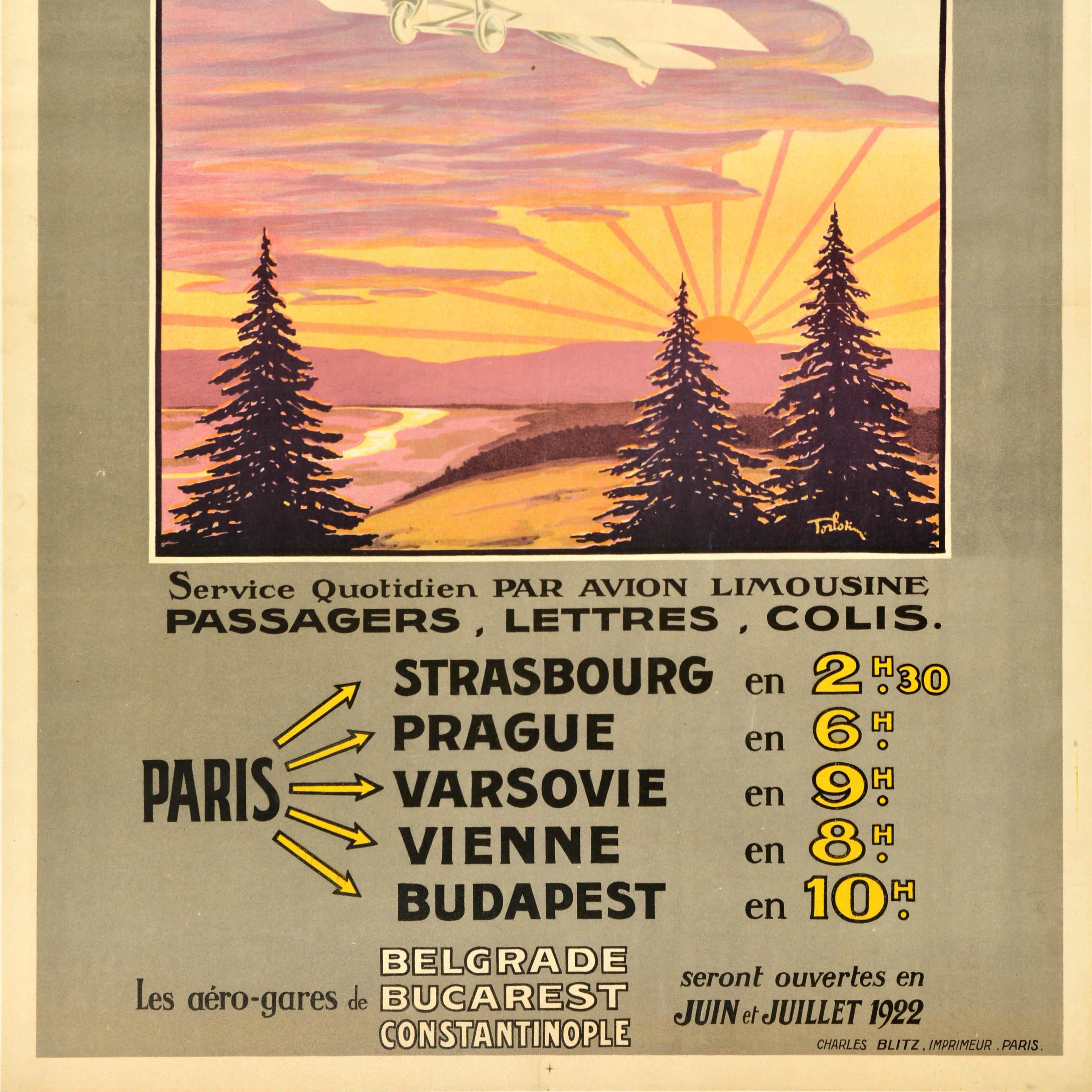 Original antique travel advertising poster for the Compagnie Franco Roumaine de Navigation Aerienne / French Romanian Company for Air Transport featuring great artwork of a plane flying above fir trees with a river in the countryside below and red