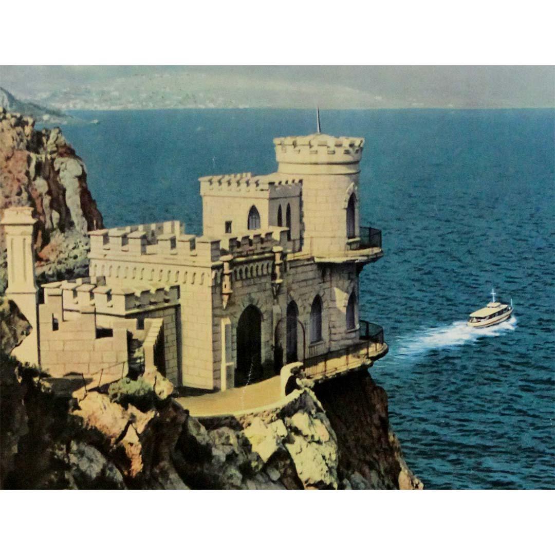 This breathtaking original Soviet Intourist travel poster showcases one of Crimea’s most iconic landmarks—the Swallow’s Nest (Nid de l’Hirondelle)—perched dramatically on the edge of the Aurora Cliff, overlooking the Black Sea.

Published by