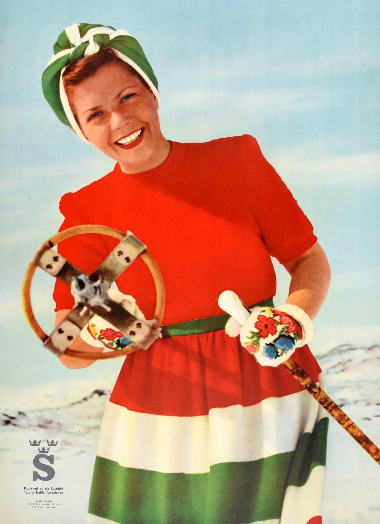 Original vintage ski travel poster for Sweden featuring a fun image of a smiling lady wearing a bright red, white and green dress with a head scarf and floral patterned gloves standing on a snowy mountain and pointing a wooden ski pole at the