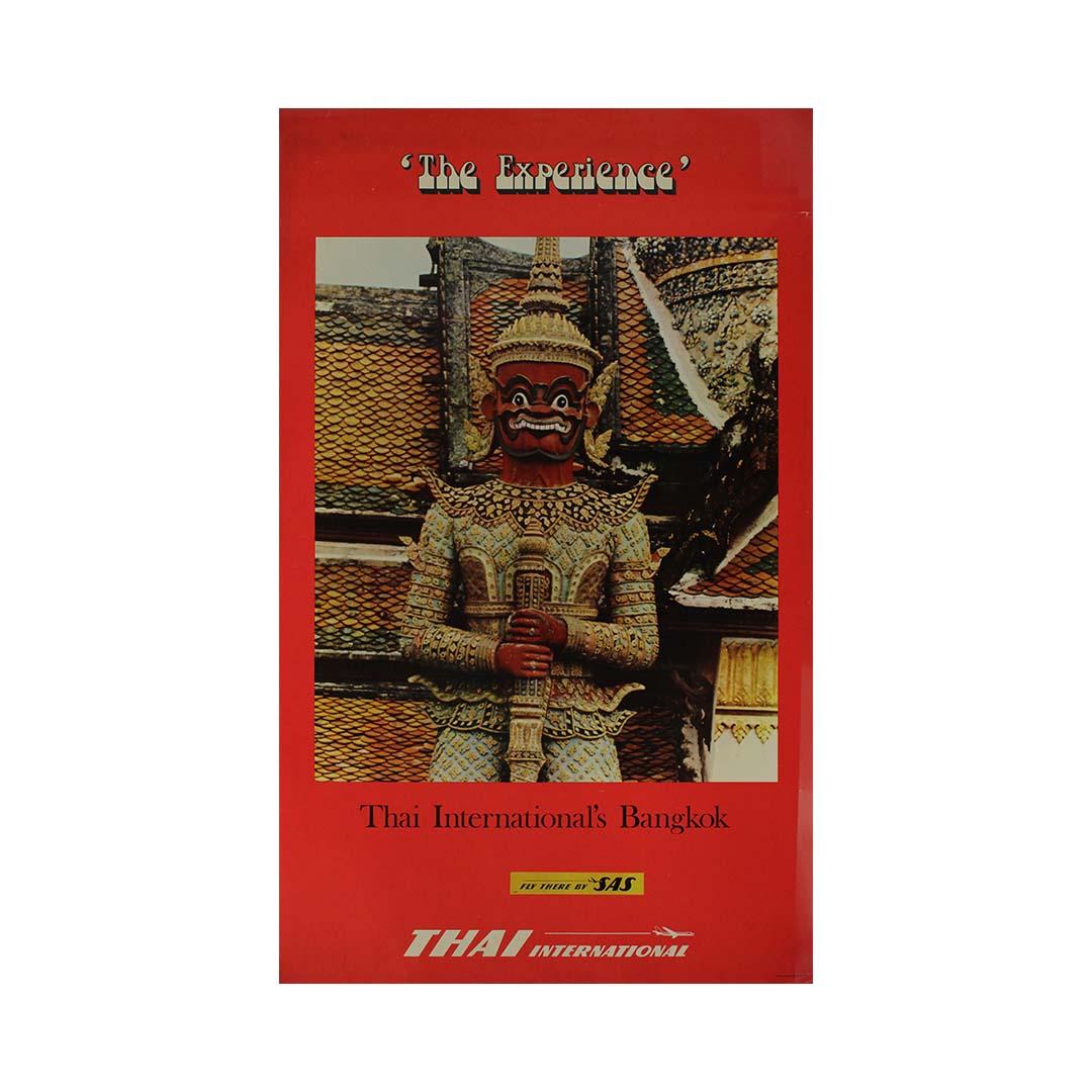 This striking 1950s travel poster for Thai International (now Thai Airways) captures the allure and mystique of Bangkok, Thailand, inviting travelers to immerse themselves in “The Experience.”

At the center of the design is a Yaksha guardian