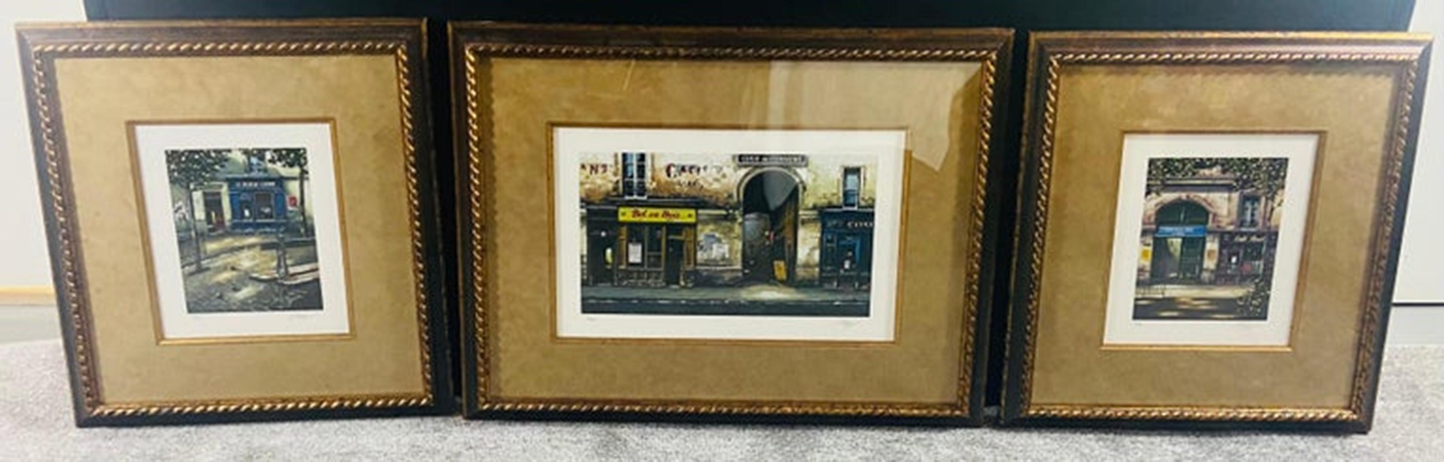 A set of three beautiful framed and matted prints depicting scenes of the street of Paris. Full of life and creativity, the streets of the city of lights seduce us with its artisan shops and colorful business signs and glamorous cafes and bistros.