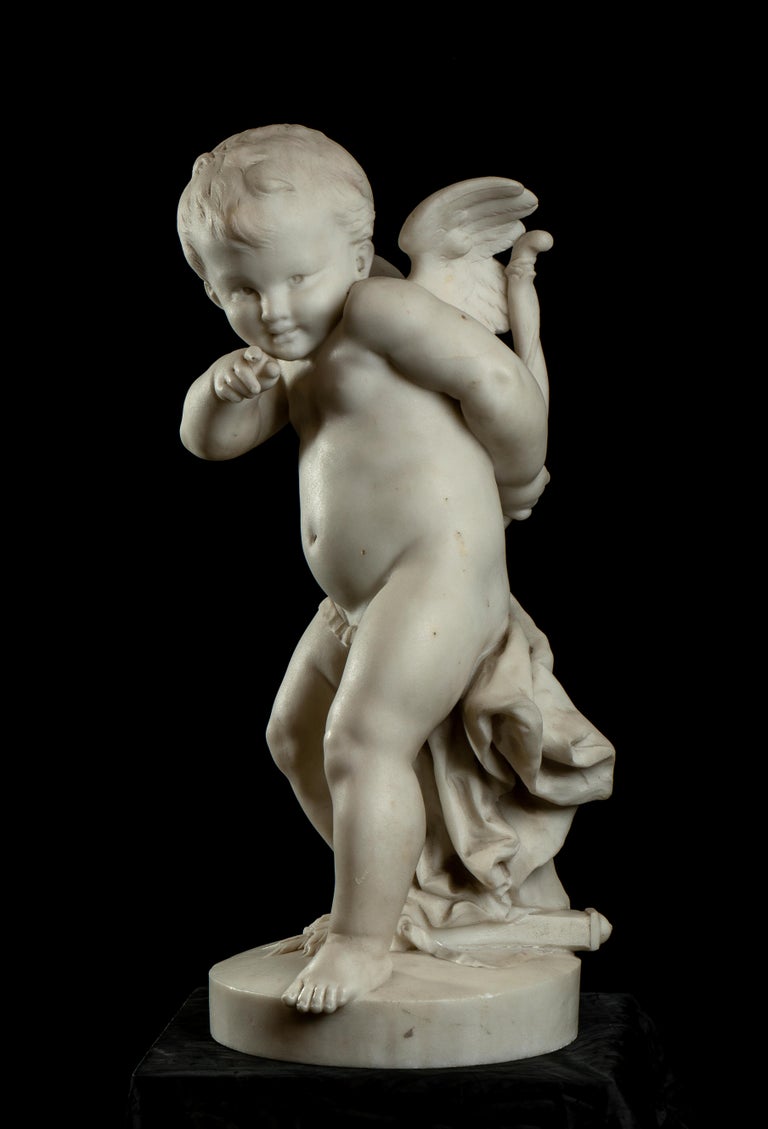 a very beautiful carved white marble sculpture of Cupid. The opera show a dynamic Cupid that is pointing with the index finger of the right hand finger and bring in the left hand his bow, just to be prepare to shoot his arrow.
The sculpture present