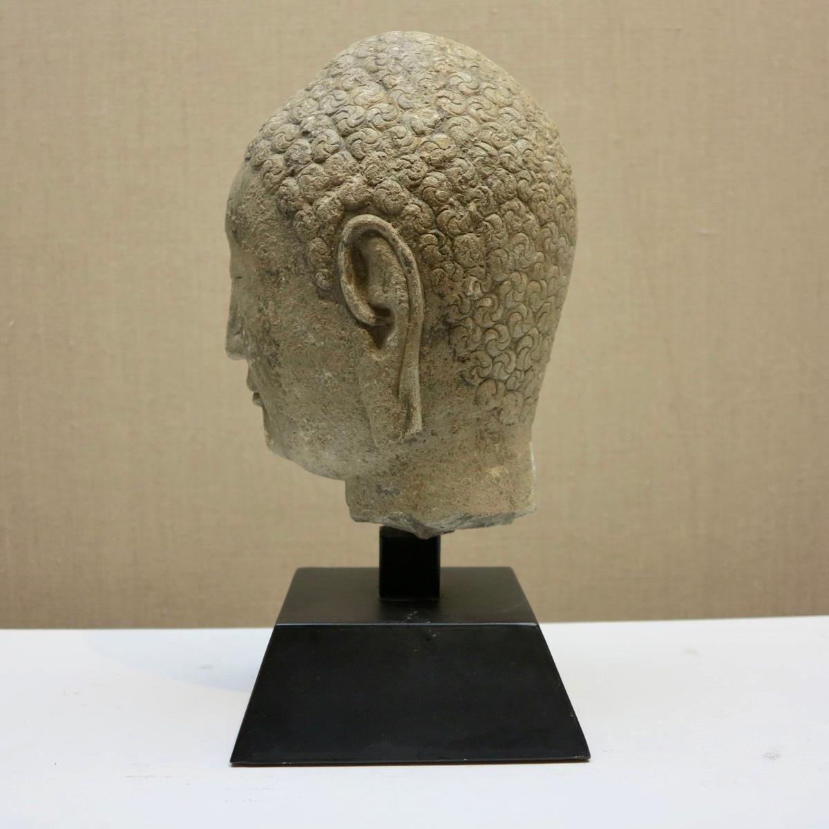 Beautiful antique Chinese head of Buddha. Qi Dynasty, 6th-century, carved limestone measures h. 8.75 in., w. 5 3/8 in., w. 6.75 in. Measures 13 inches tall on base. Footprint of base measures 6.25 inches square. Provenance: Ho Family Collection,