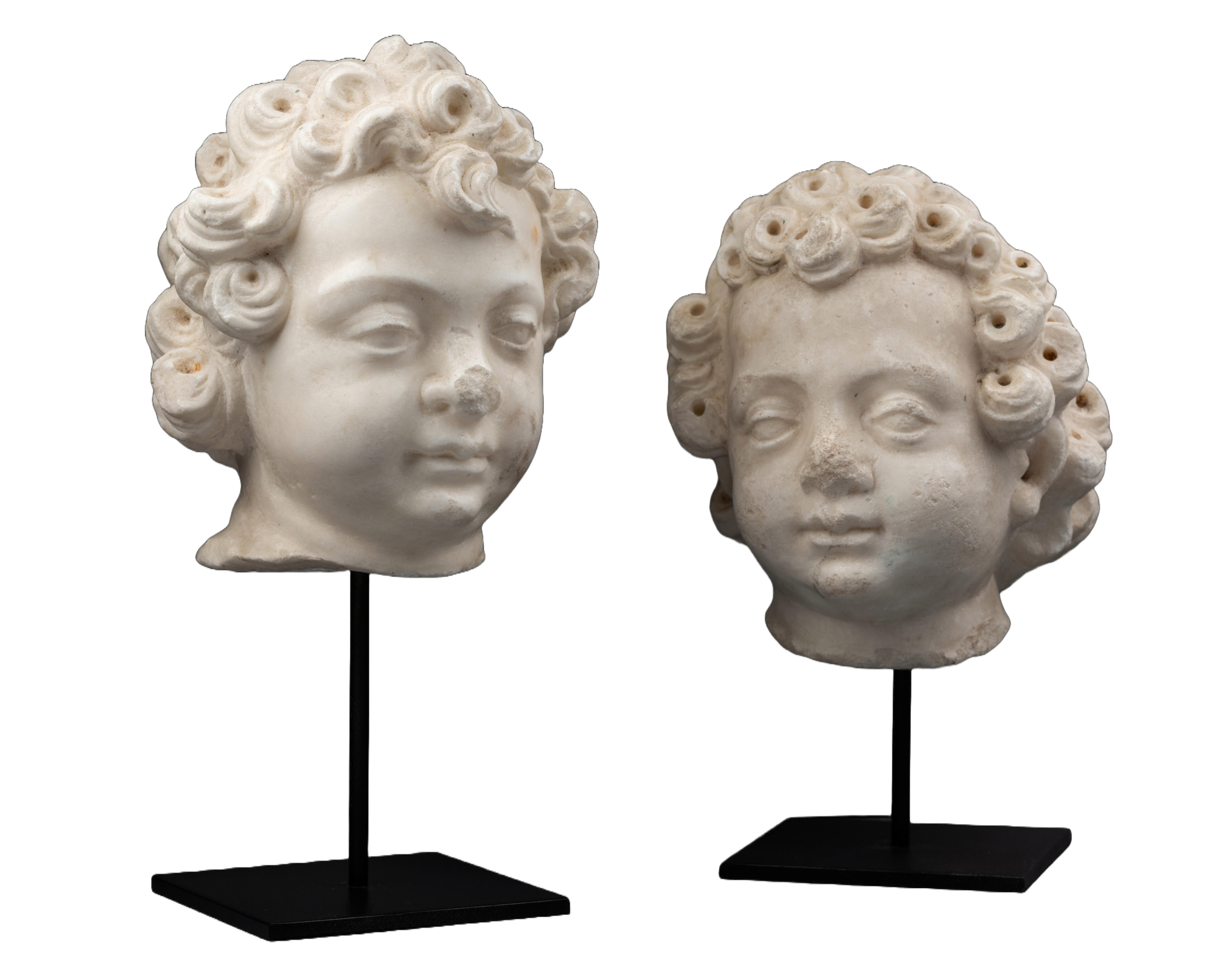 Unknown Figurative Sculpture - A 16th century Renaissance North Italian marble heads of two puttis