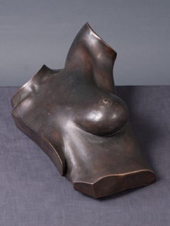 A bronze sculpture of a female torso