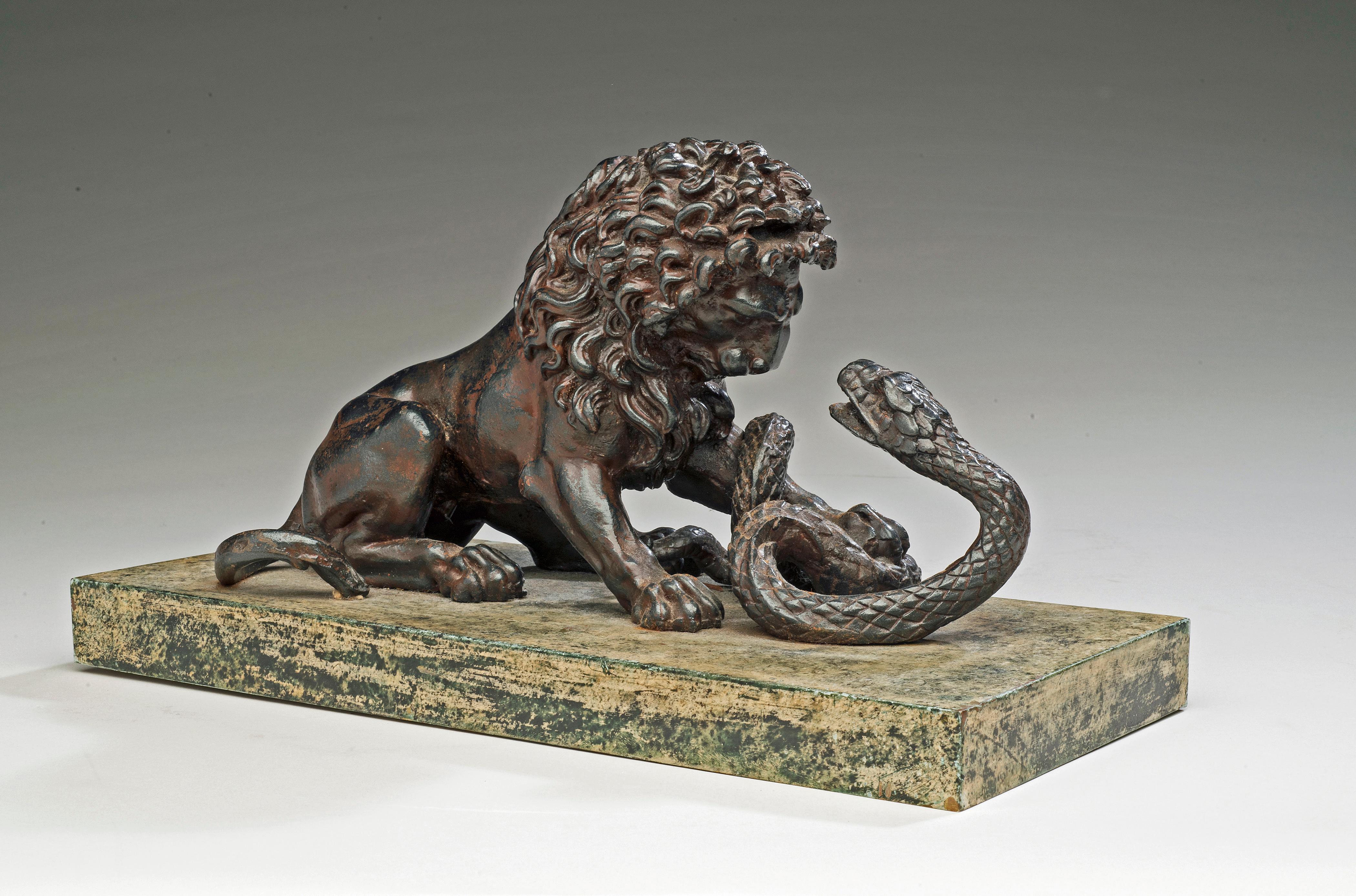 A Cast Iron Lion and Serpent Sculpture After Antoine-Louis Barye. - Gray Figurative Sculpture by Unknown