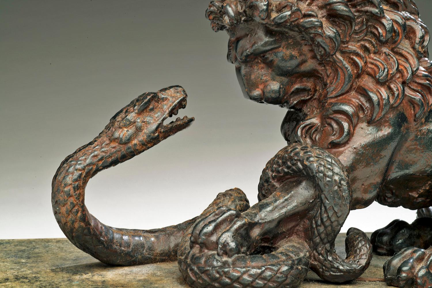 Unknown Figurative Sculpture - A Cast Iron Lion and Serpent Sculpture After Antoine-Louis Barye.