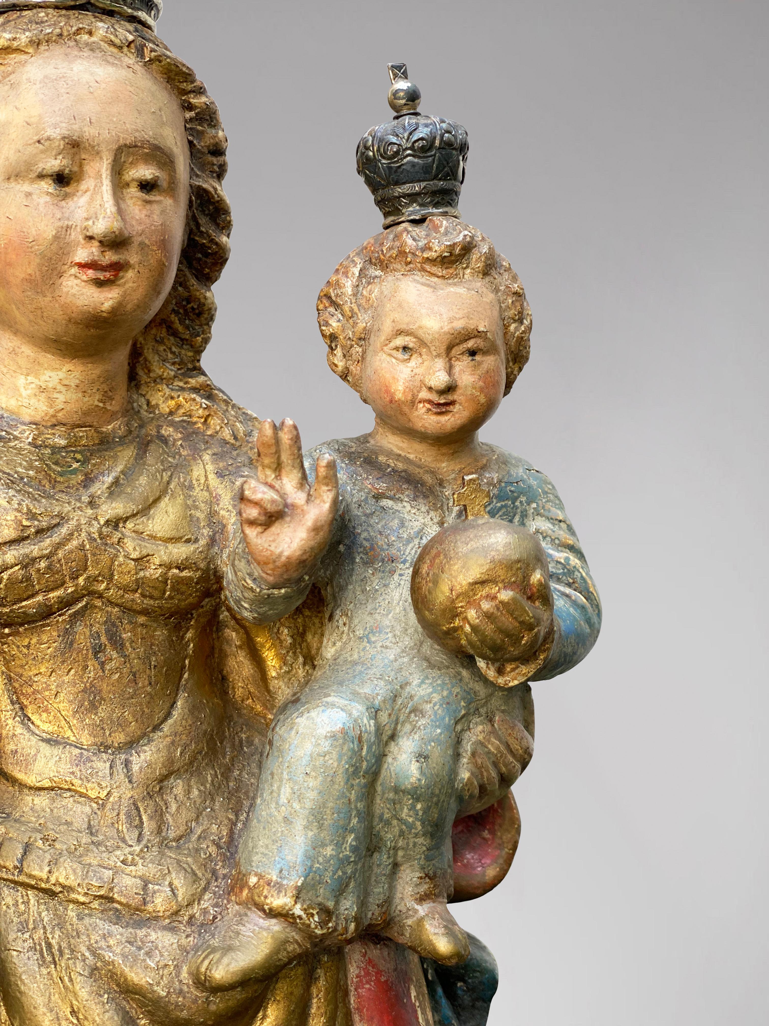 Description: A Flemish Statue of Crowned Virgin Mary with Child Jesus, 17th Century, polychromed wood, silver crowns

Statue: Crowned Madonna and Child

Object Type: Statuette

Artist, Sculptor / Creator: Unknown

Place of Origin: Flanders

Period: