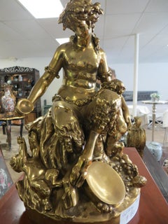 Antique A GOLD PATINATED BRONZE SITTING FAUN