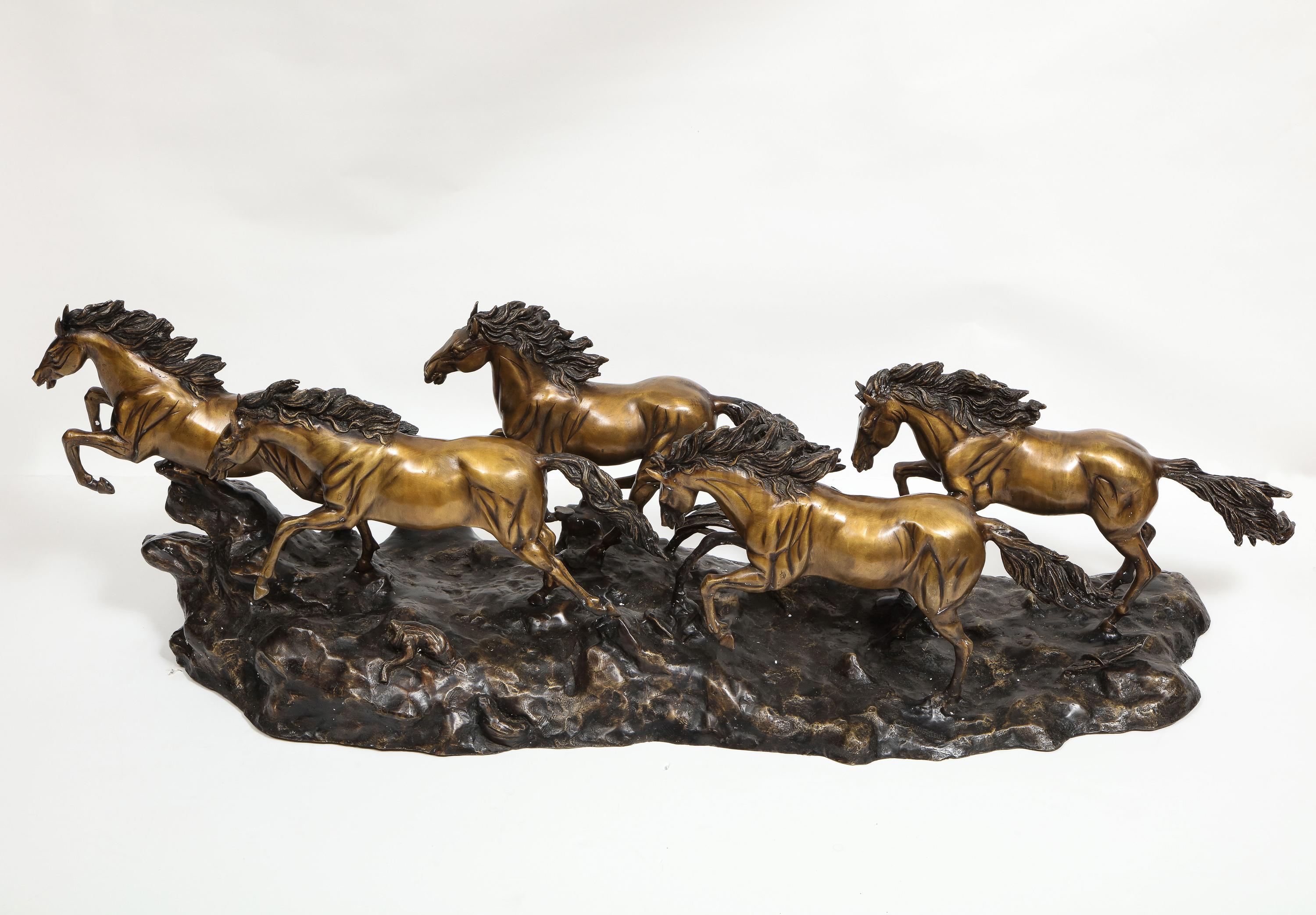 A Massive Patinated Bronze Sculpture of Running Horses 1