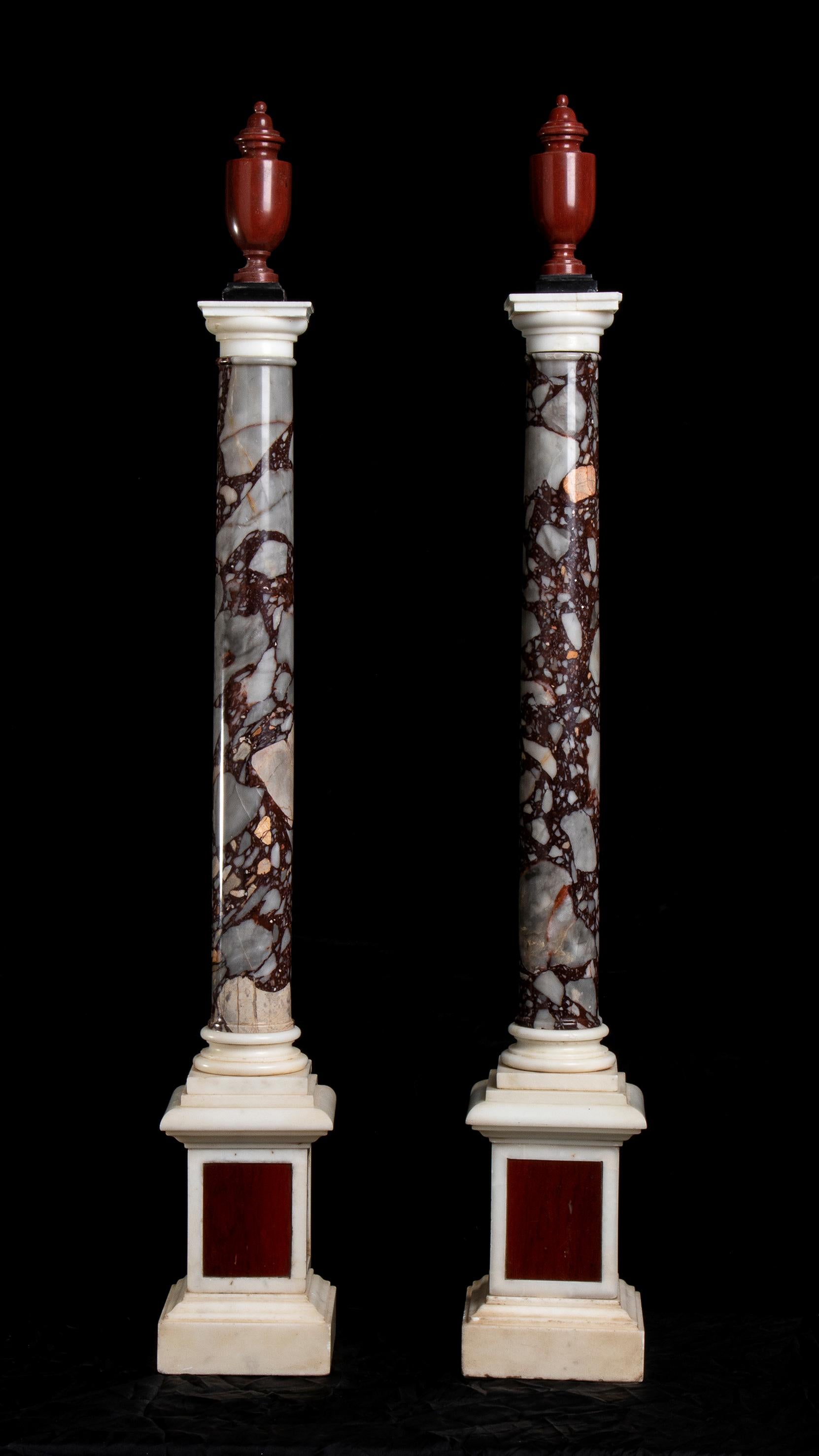 Unknown Figurative Sculpture - A Pair Of Italian Breccia White and Marble Columns Each Surmounted by an Amphora