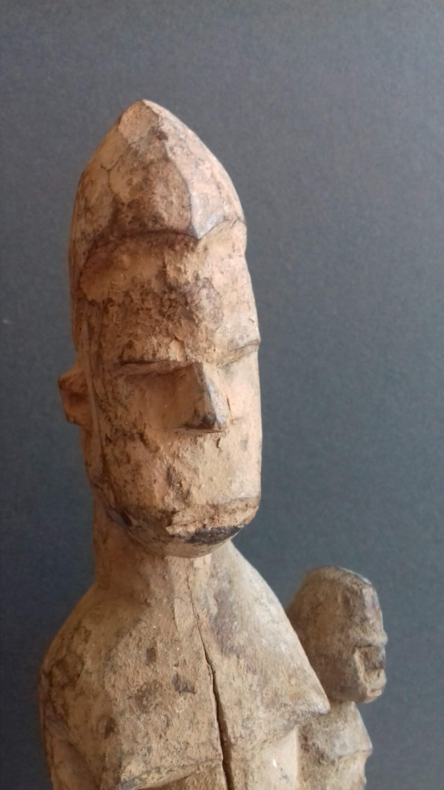 A delightful African maternity figure from the Lobi peoples of the Ivory Coast/Ghana. With a serene yet feisty expression, the mother is carrying the baby on her hip. According to Daniela Bognolo's reference work 