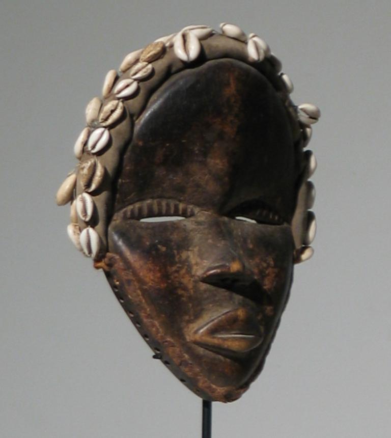 African
Dan
Mask (Female)
Carved Wood, Textile, Cowry Shells,
and Braided Fibrous Material
10 x 7.5 x 2.5 inches
