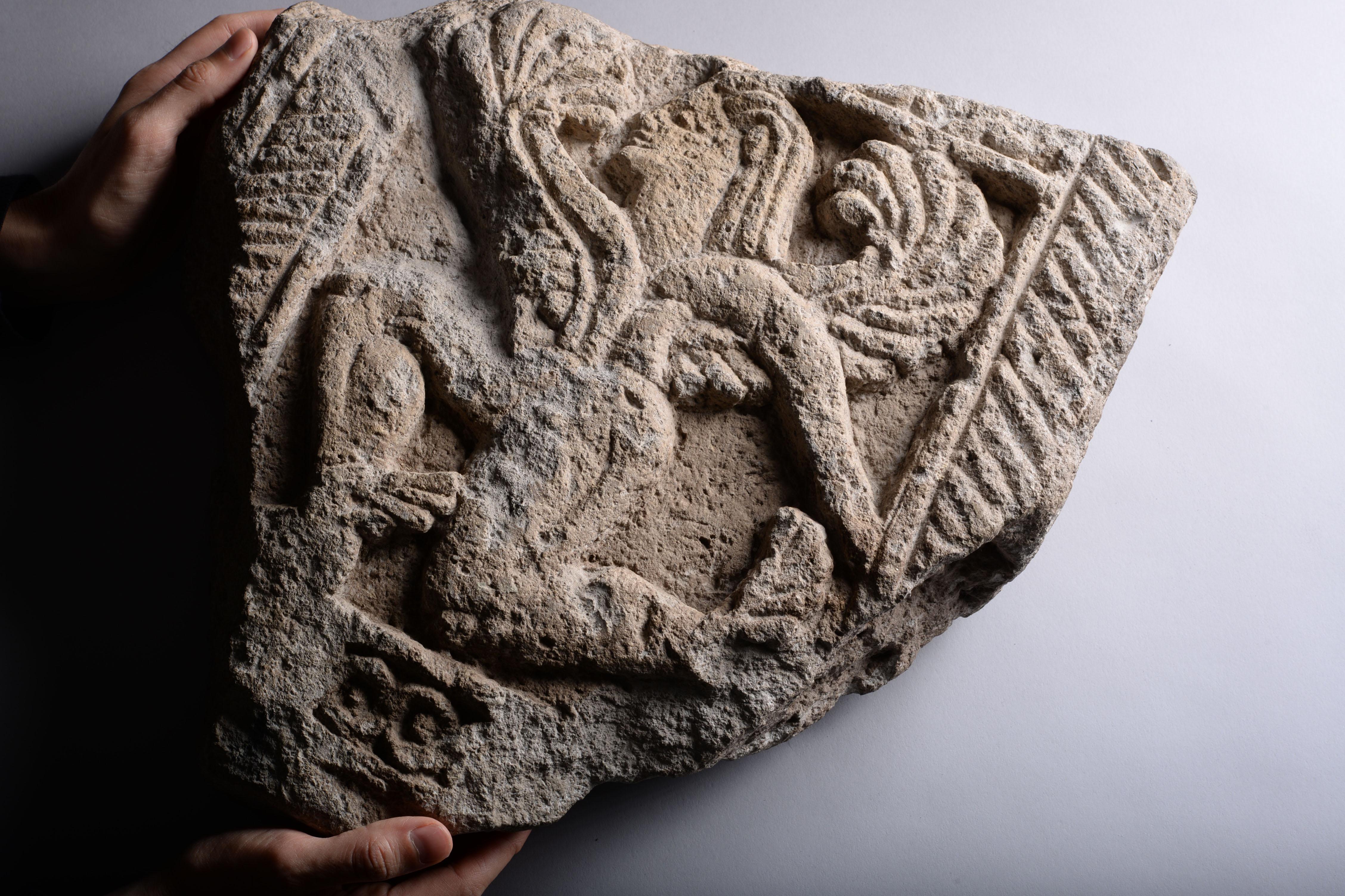 Ancient Etruscan Stone Relief of a Winged God - Black Figurative Sculpture by Unknown