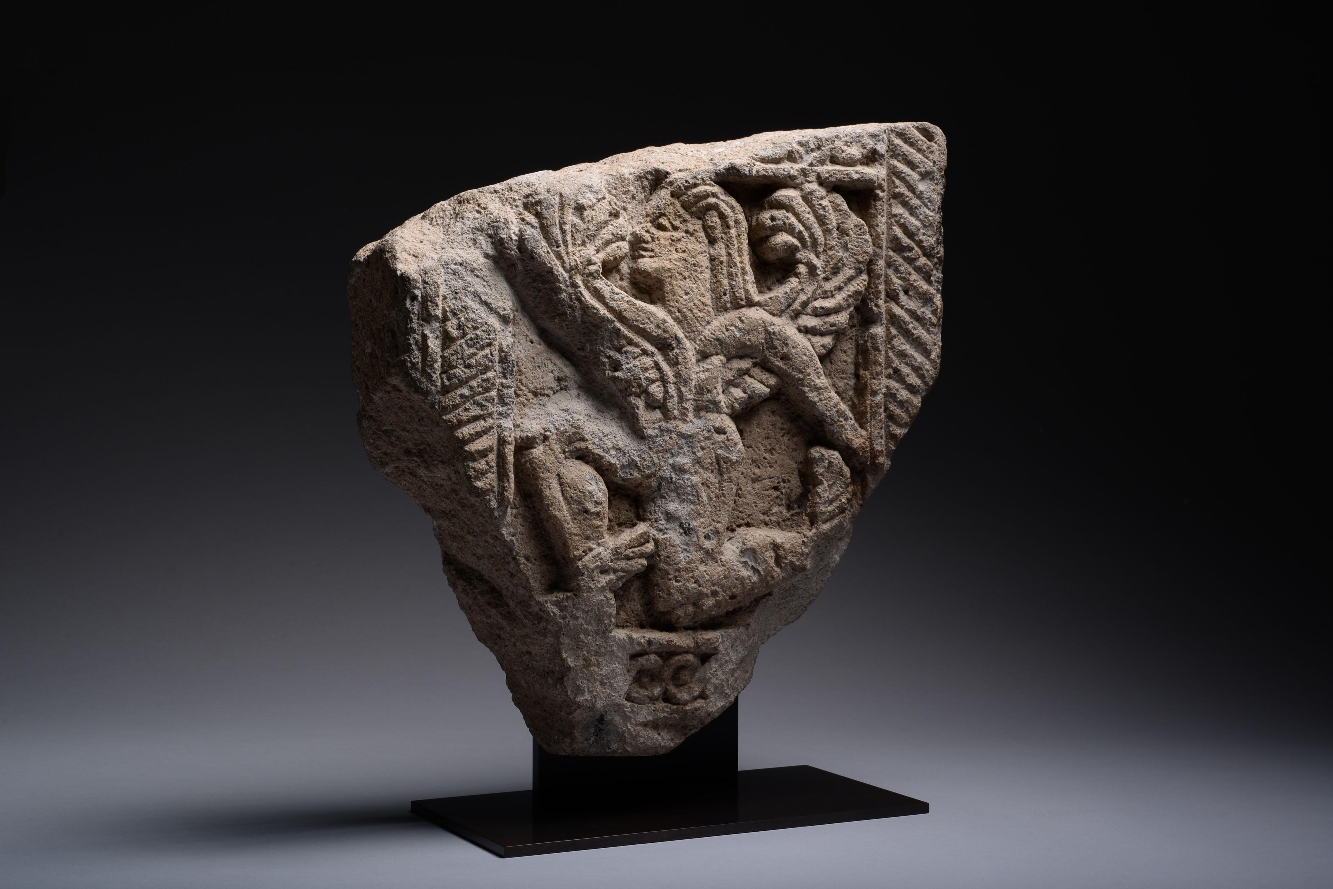Unknown Figurative Sculpture - Ancient Etruscan Stone Relief of a Winged God