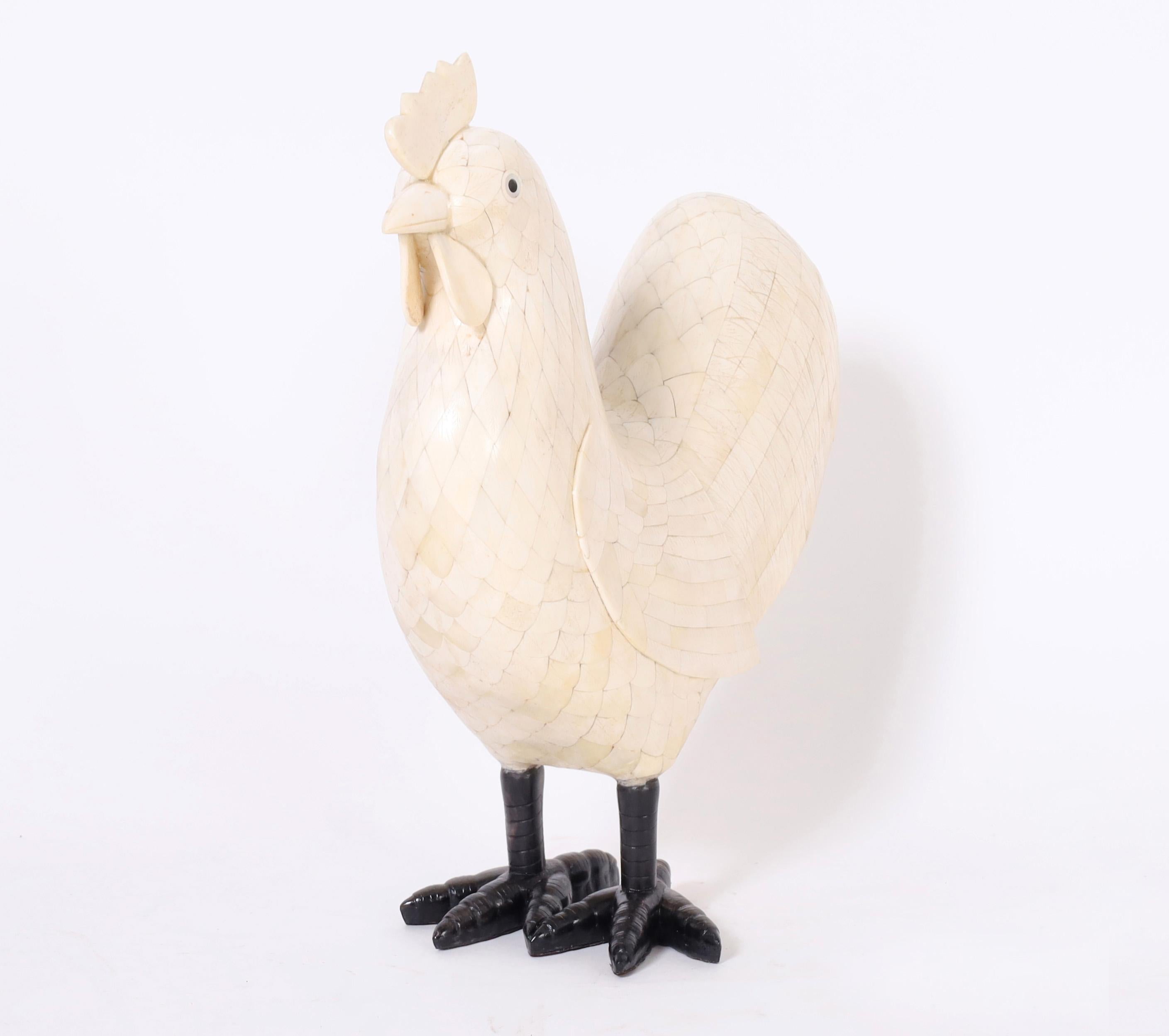 Whimsical mid century rooster clad in a faux feather bone mosaic on ebonized feet.