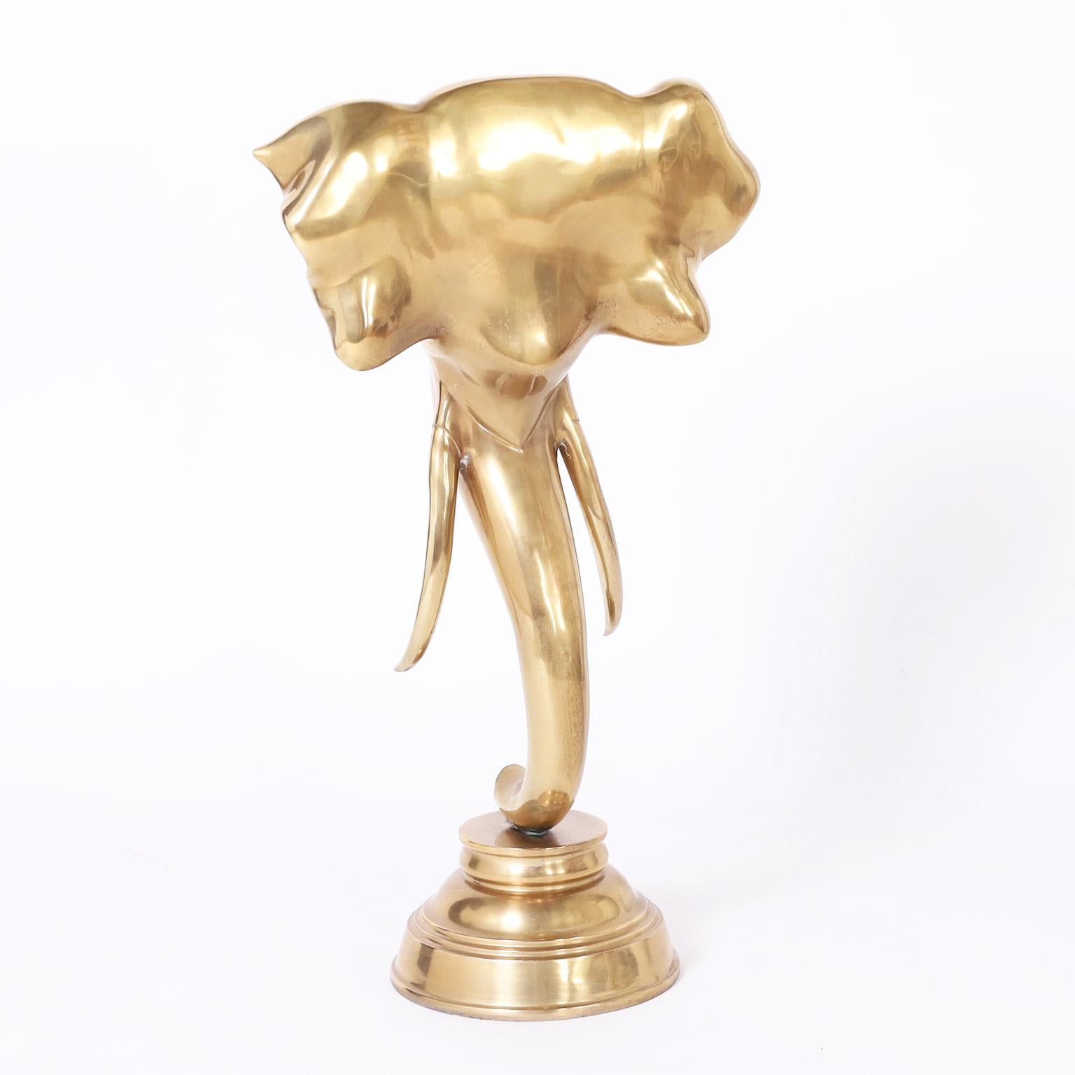 Standout Anglo Indian cast brass elephant head sculpture presented on a turned brass stand. Hand polished and lacquered for easy care.