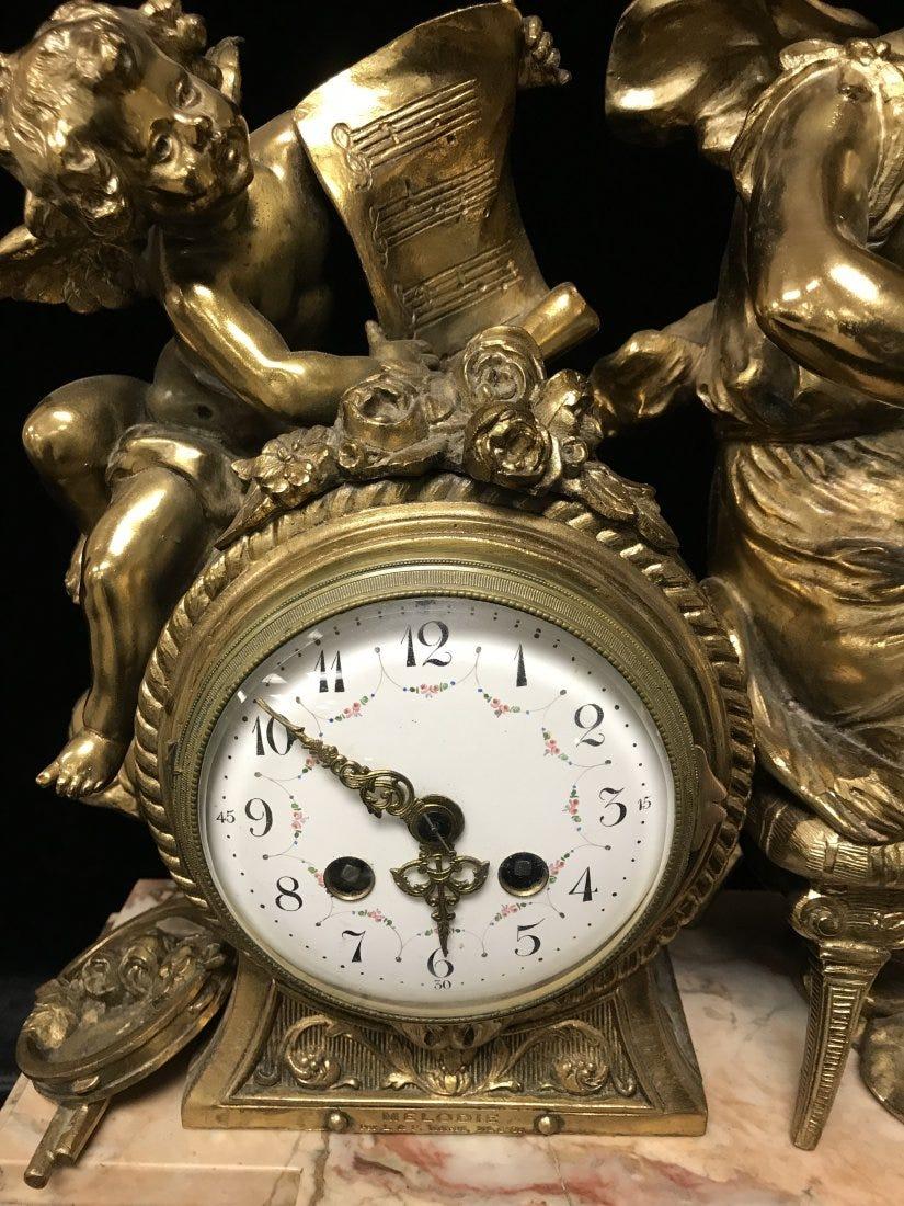 A Large French Gilt Bronze & Marble Mantel Clock Depicting a  woman on violin with cherubin.
Napoleon III period .