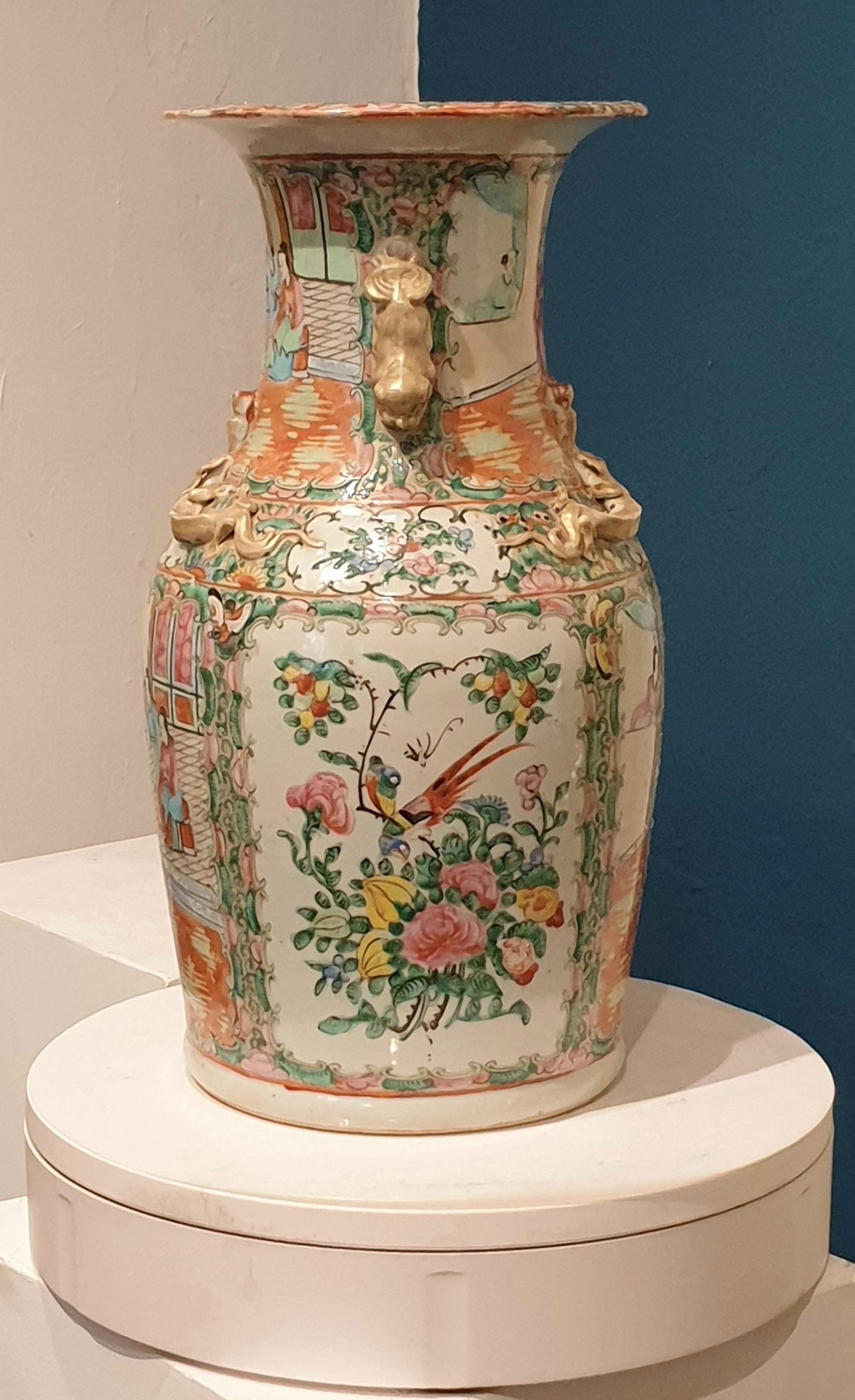 A mid-nineteenth century Chinese 'famille rose' (also referred to as 'rose medallion') porcelain vase with applied gilded dragons to the shoulder, handles and to the neck, decorated with enamels throughout with figurative cartouches of a courtyard