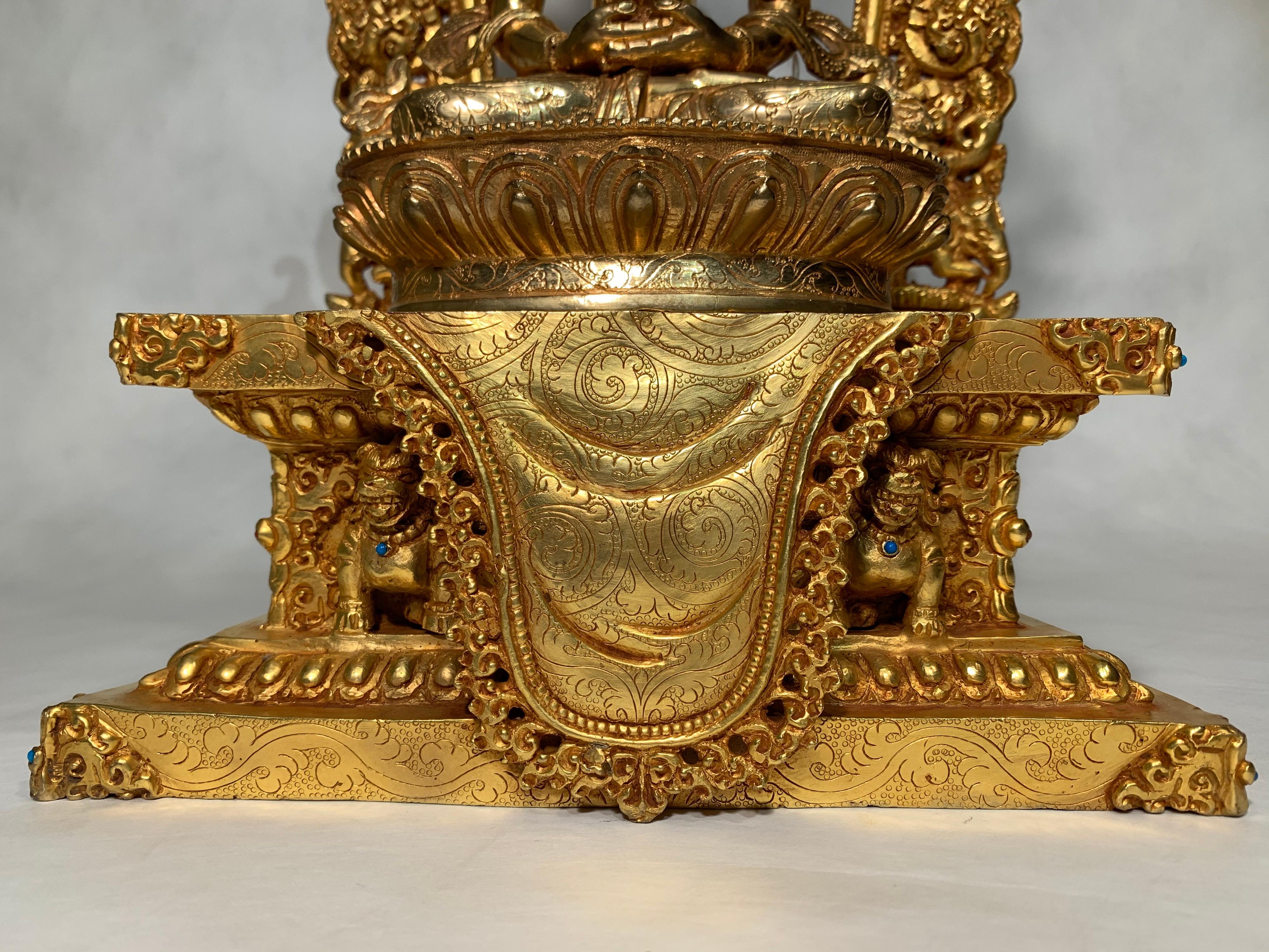 This handcrafted Aparmita statue is made by lost wax process which is one of the ancient process of making metal sculptures. It is fully 24 carat gold overlay on copper. Aparmita figure is seated on a golden throne which is adorned by several