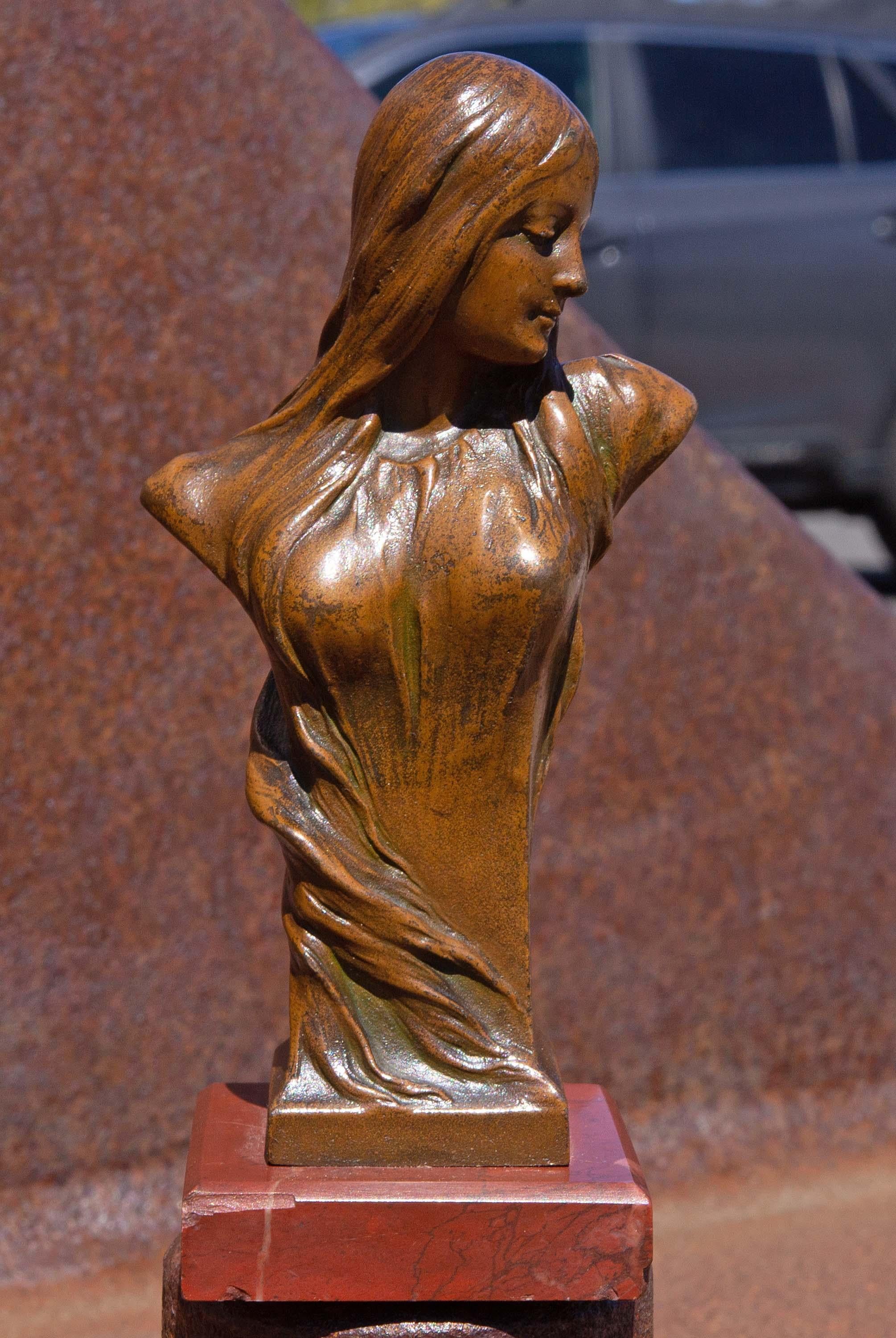 Bronze Art Nouveau sculpture of a young woman with flowing hair. Mounted on rouge marble base. Circa 1900. Measure: 4 3/4