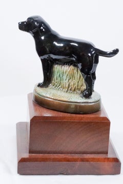 Black Labrador Retriever hand  cast and hand painted mounted on a wood base 