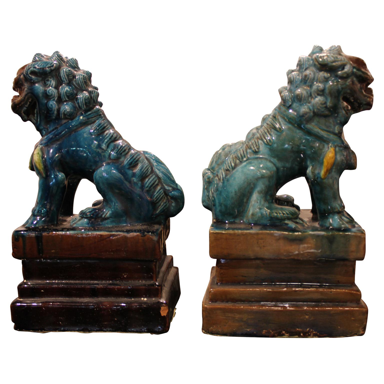Set of beautiful ceramic foo dog bookends glazed in a rich turquoise color.  The base is not a separate piece. Sold as a set of 2.  