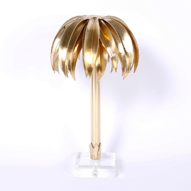 Midcentury brass palm tree sculpture with Brutalist style cerated edges, sleek stylized trunk, and presented on a Lucite base.