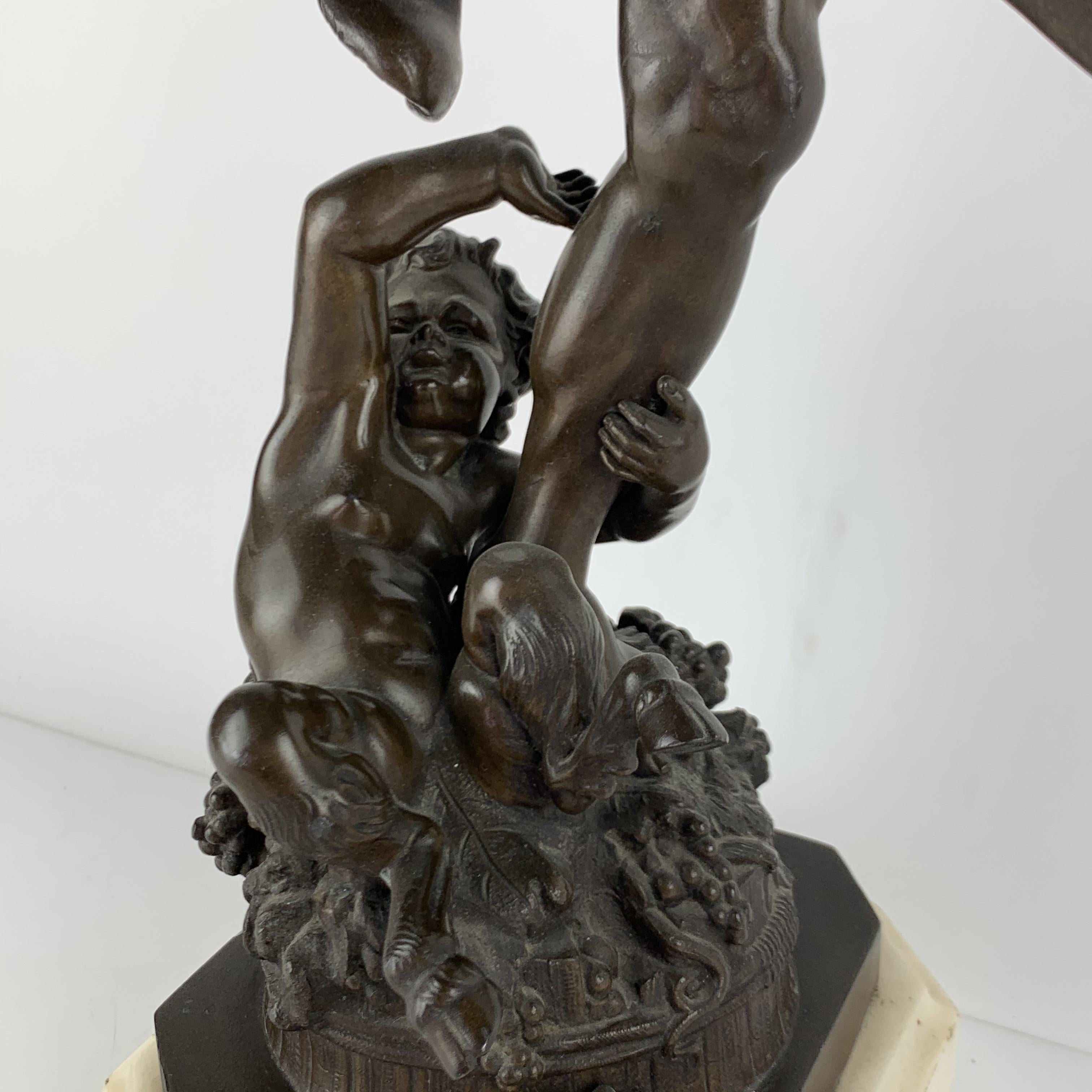 Bronze of a Dancing Bacchus with a child Faun  - Gold Figurative Sculpture by Unknown