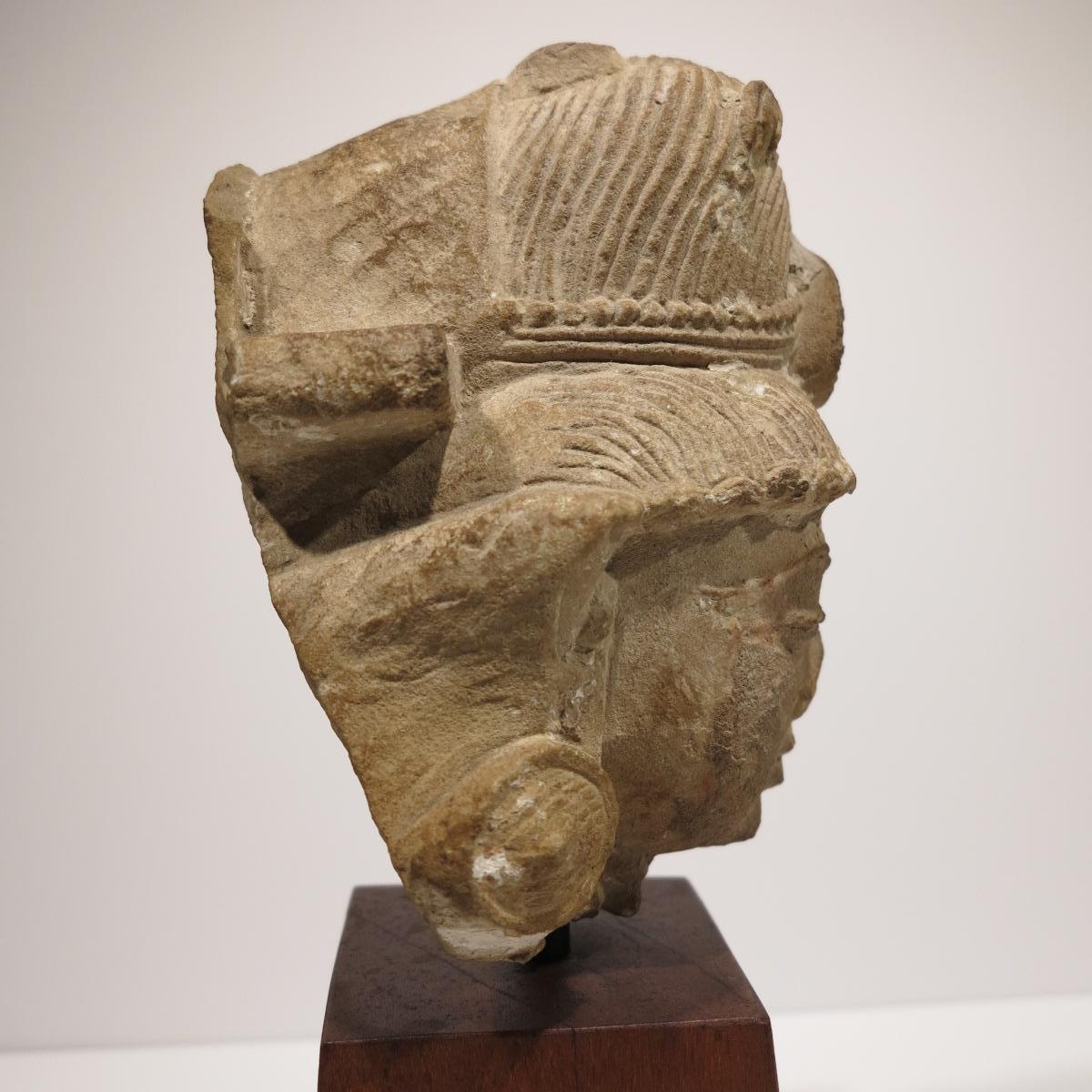 Beautiful 10th century bust of an Indian Deity. Buff sandstone, measures 8.25 x 5.25 x 6 inches. Measures 14.75 inches tall on wood base. 

Provenance: Ken Shores collection. 