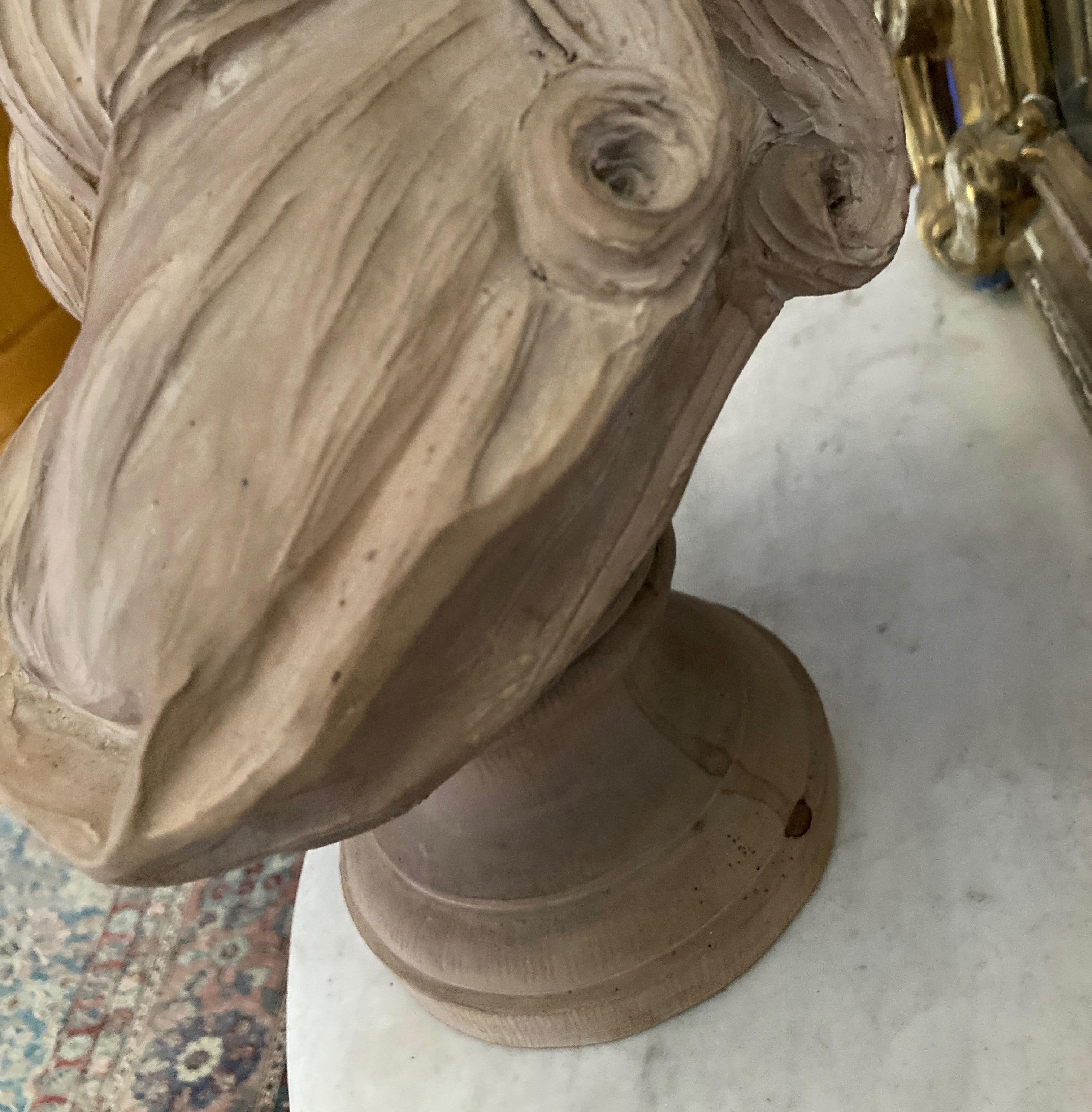 A powerful presentation piece, this stunning bust of Jean Bécu - Comtesse du Barry is both beautiful and tragic. Executed in terracotta that has been left natural and shows a complex range of color. It rests over an oval/ round shaped socle.
French