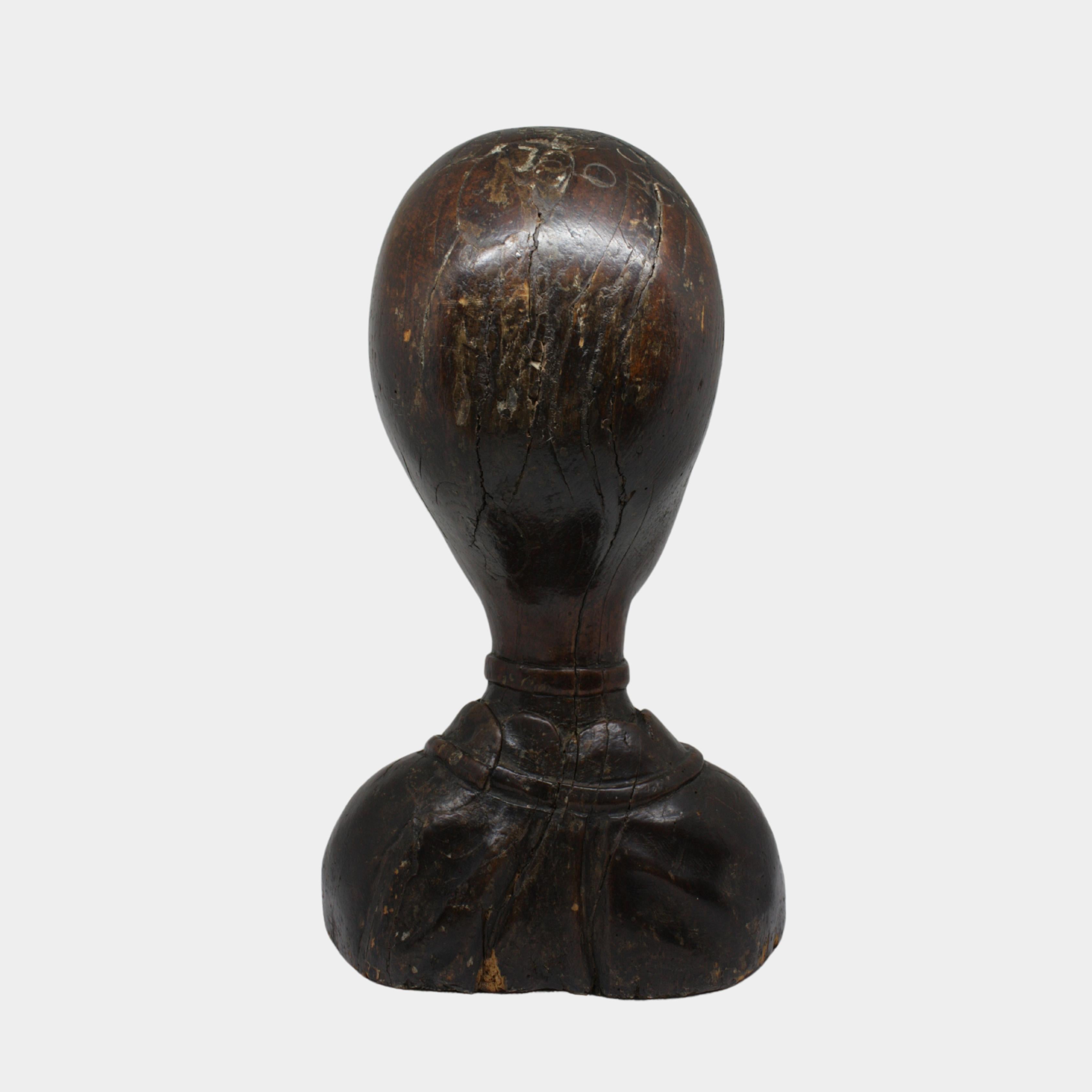 Raro e affascinante busto femminile in legno scolpito, probabilmente utilizzato come porta parrucca. L'opera, realizzata in Olanda nella prima metà del XVII secolo, presenta un'elegante stilizzazione dei tratti del volto, con lineamenti raffinati e
