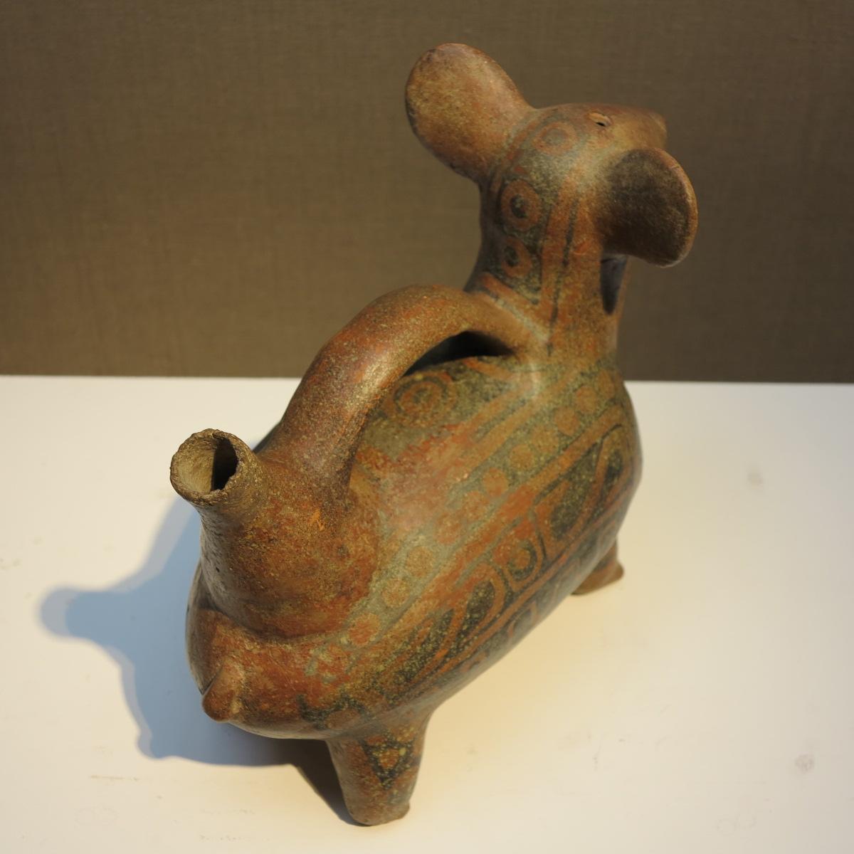 Vicus Dog. Peruvian, c. 200 A.D. Painted terracotta, h. 8 7/7 in., l. 7 7/8 in., w. 4.5 inches. 

The Vicús culture (200 B.C.-600 A.D.) reigned in the northernmost corner of Peru´s coastal area. Several details of art and architecture link it with