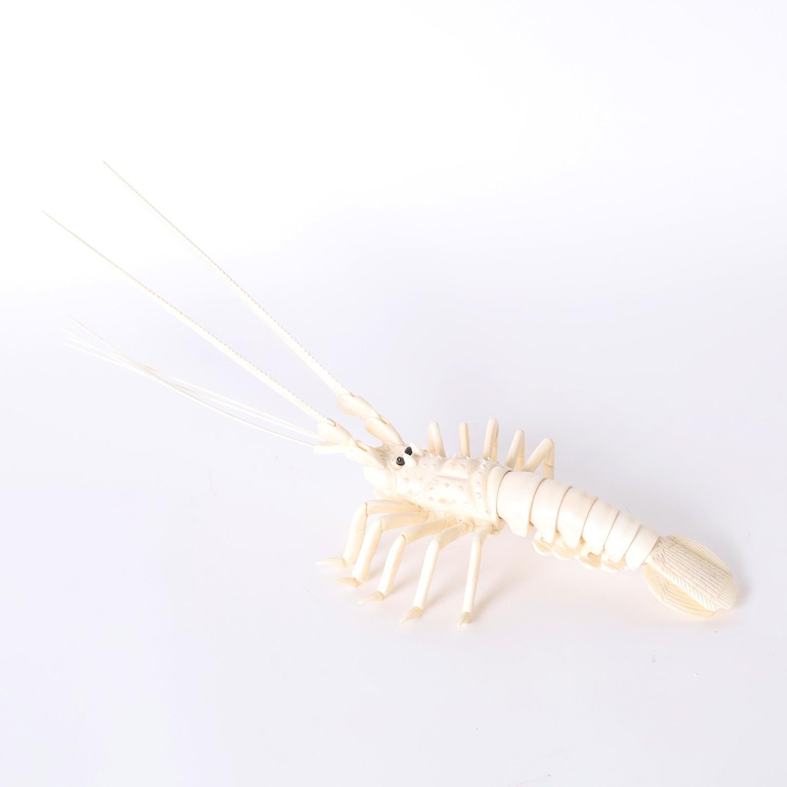 Lobster sculpture or object of art crafted in carved bone with hinged antennae and flexible tail. 

These are no longer being made.