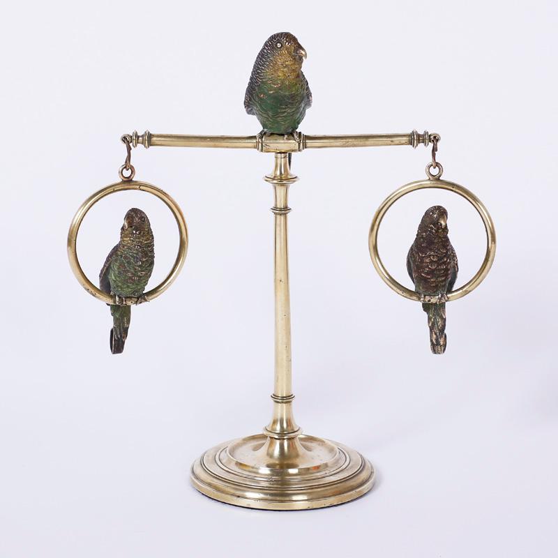 Three Vienna cast bronze and cold painted parakeets or birds perched on a brass Stand with a Classic turned base, in the manner of Franz Bergman.
