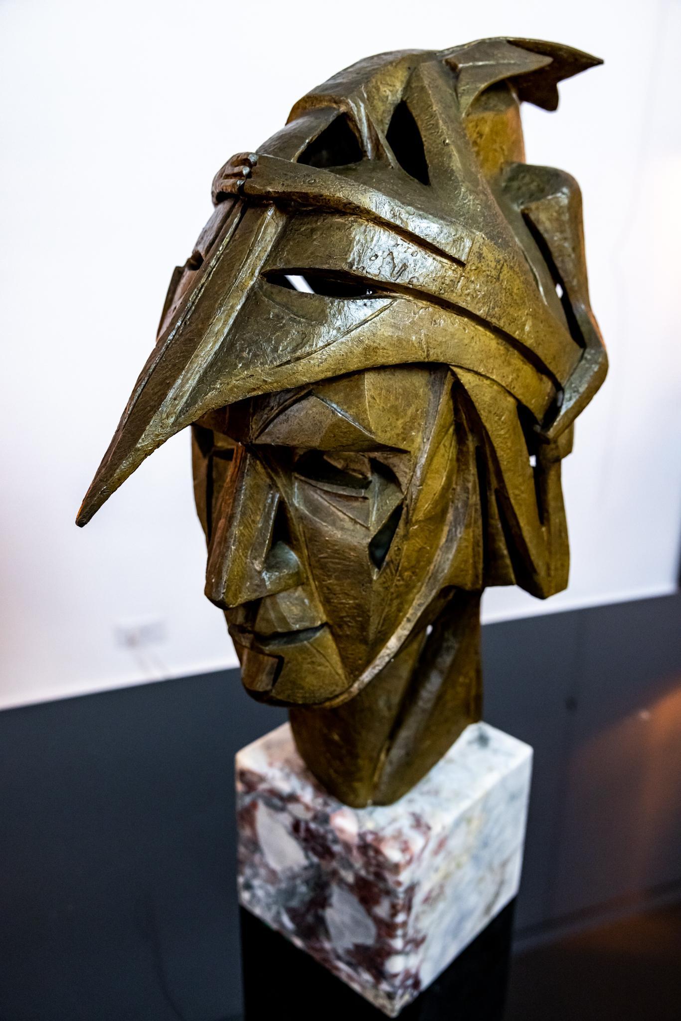 A wonderful stylized bust of a warrior. It appears that a dragon like creature sits on his helmet, rather is his helmet. You can't help but draw similarities to Game of Thrones. This would make any GOT fan happy! the bronze sits atop a cube of