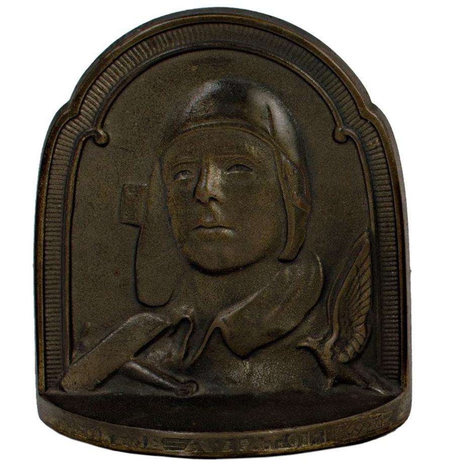 These cast bronze book ends were created by an unknown artist. They depict the American aviator, military officer, author, inventor, explorer, and environmental activist, Charles Lindbergh.

Dimensions: 5 1/2