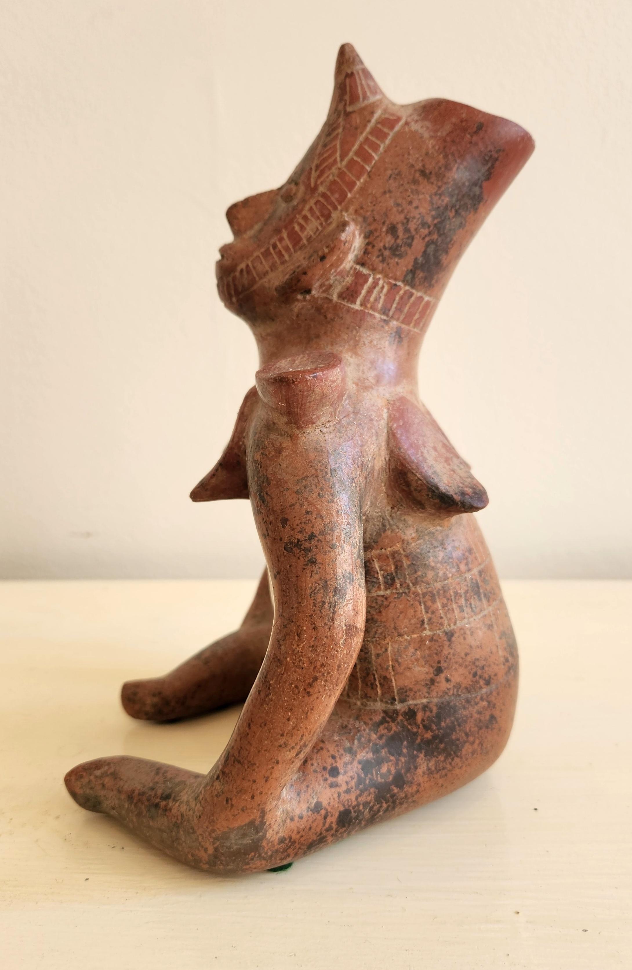 This work is made out of ceramic terracotta and is in a Pre-Columbian style. It is a reproduction of sculptures typically found in the Colima culture in western Mexico. These original sculptures usually date from around 300 BCE through 300 CE. The