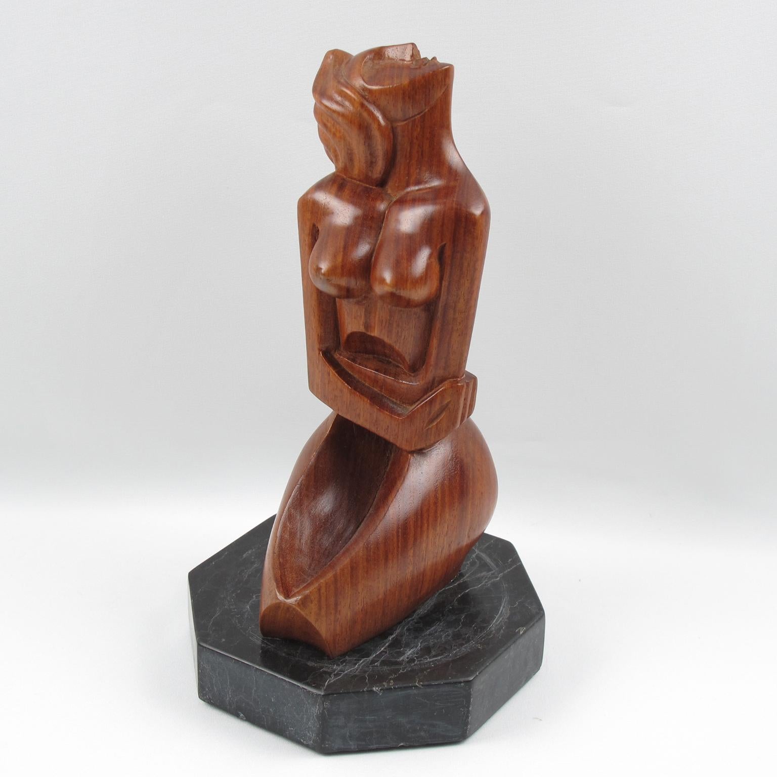 Stunning modernist 1950s wood sculpture, featuring a crouched woman in cubist style carving. Very nice carved movement of the body and the unusual position of the head. Mahogany wood all hand-carved, seating on a large faceted black marble base. No