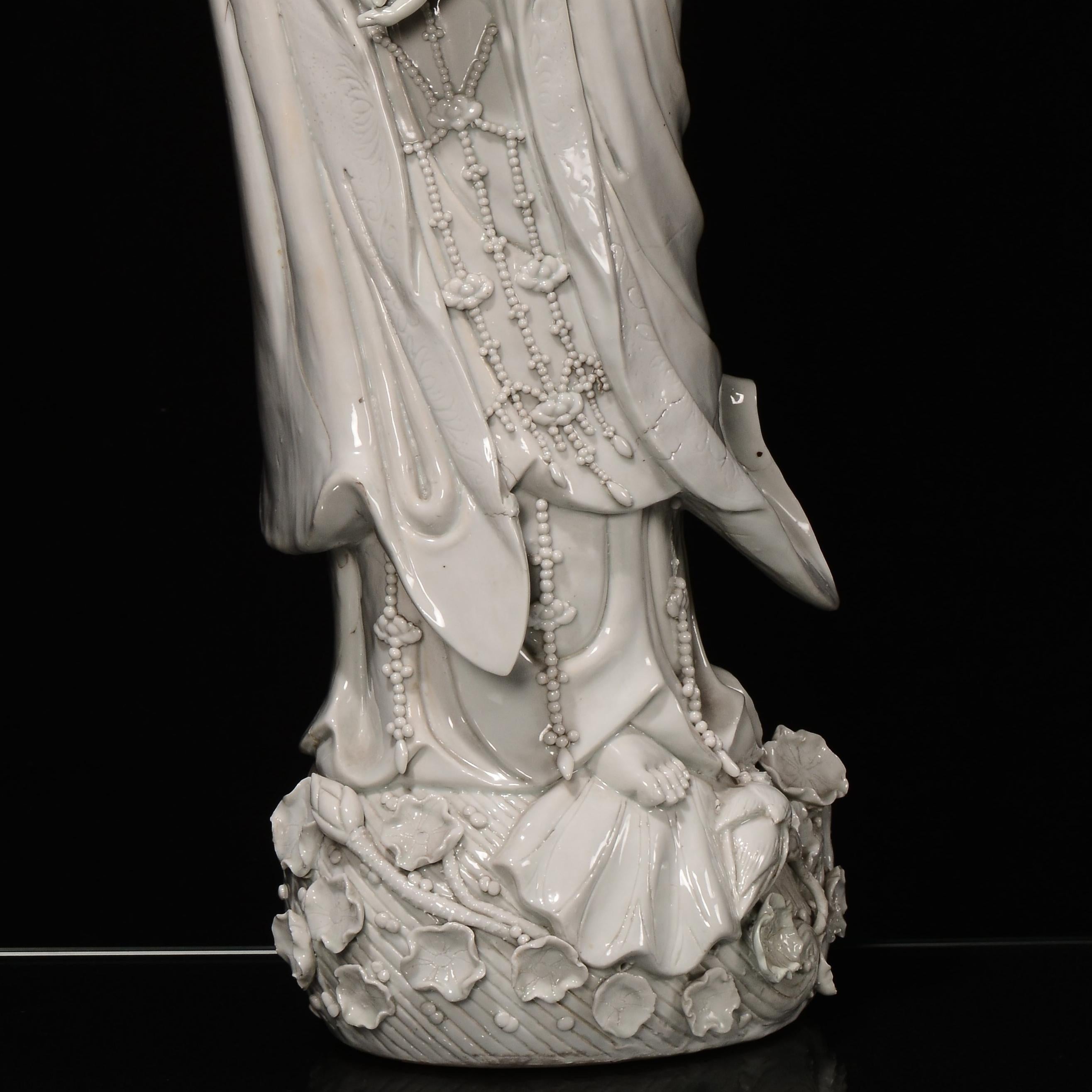 Large figure of Guanyin in White porcelain of China depicting Guan Yin, a Buddhist deity revered as the goddess of mercy, whose name is the abbreviation of the term translatable with 