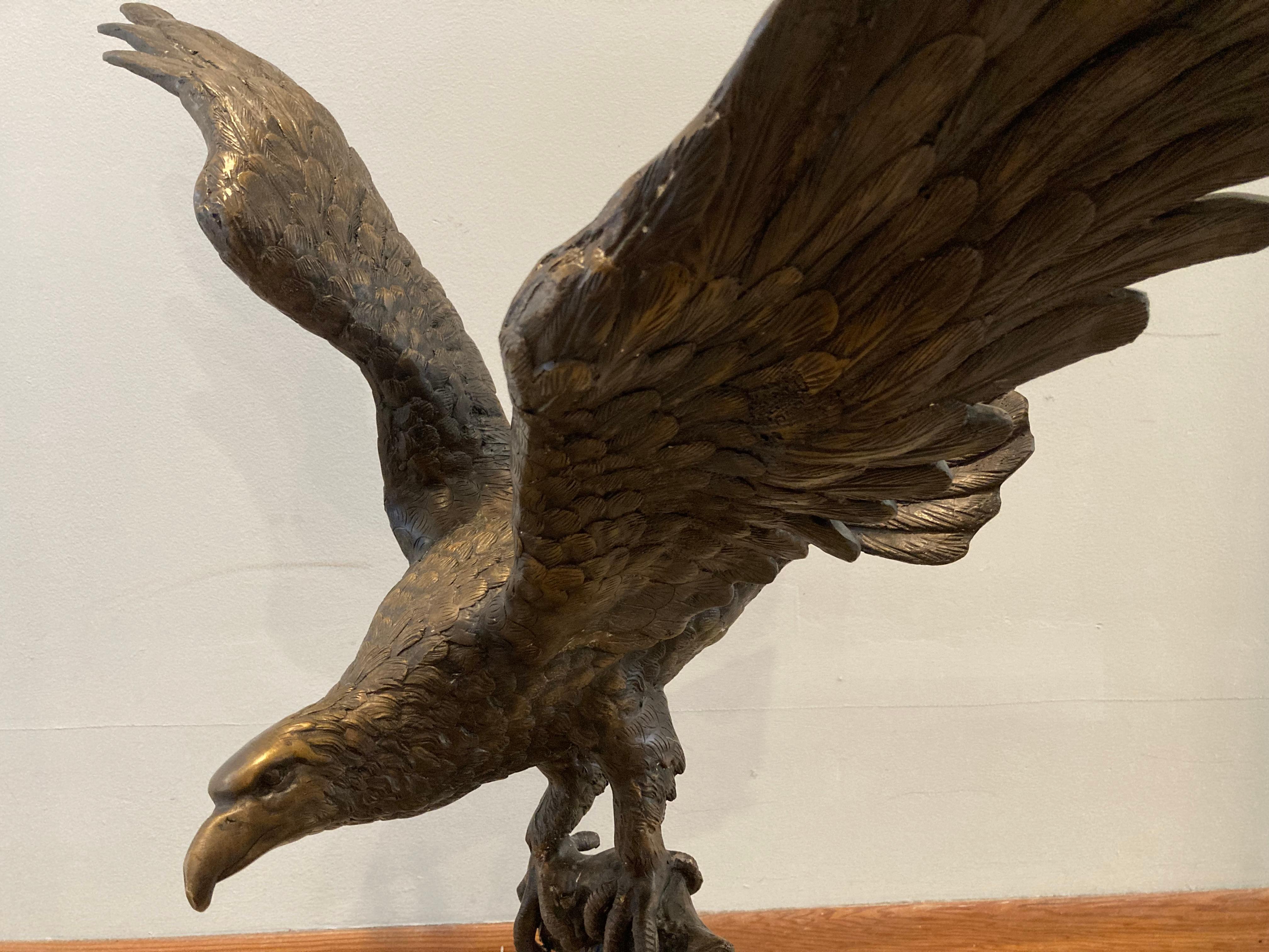 A large, powerfully affecting sculpture of an eagle perched and preparing to take off. I have included a photo of a soda can in one shot to give you an idea of the scale of this sculpture; casting anything this size costs a fortune these days. But