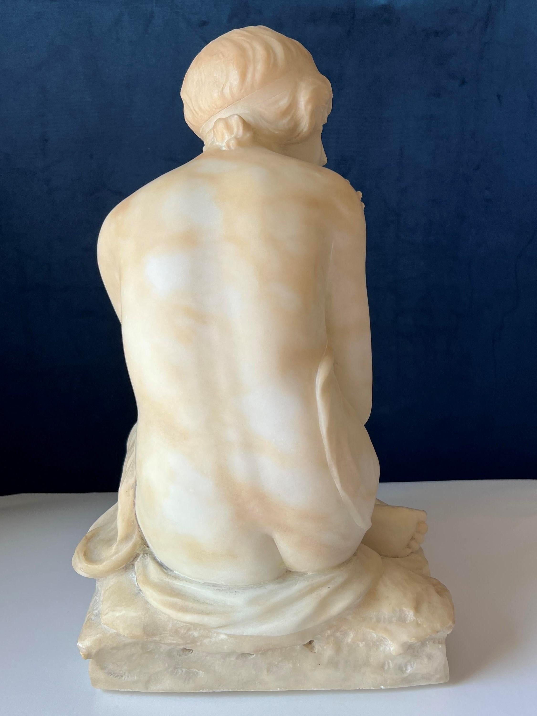 Early 20th C Italian Art Nouveau Alabaster Sculpture of a young female bather.  Bather is seated on a stone with arms crossed in a modest pose.  Bather is semi-nude.  Some minor scuffs and scratches.  Sculpture is unsigned.  Late 19th/ Early 20th C.