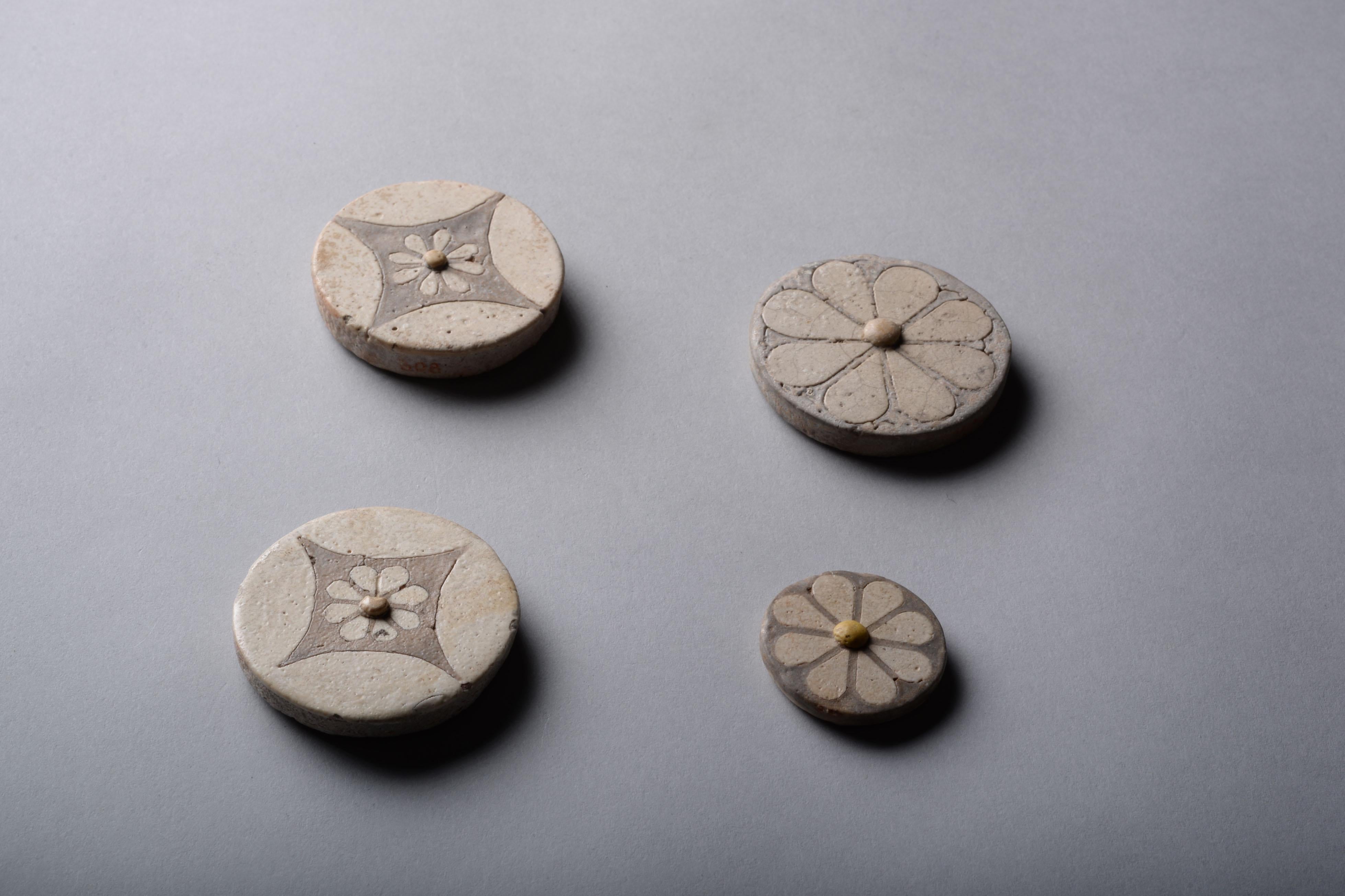 Four Egyptian faience rosettes, dating to the New Kingdom, Reign of Ramesses, 1550-1295 BC.

These remarkable inlays are often called rosettes, though they probably depict daisies or mayflowers. They demonstrate accomplishment in faience artistry,