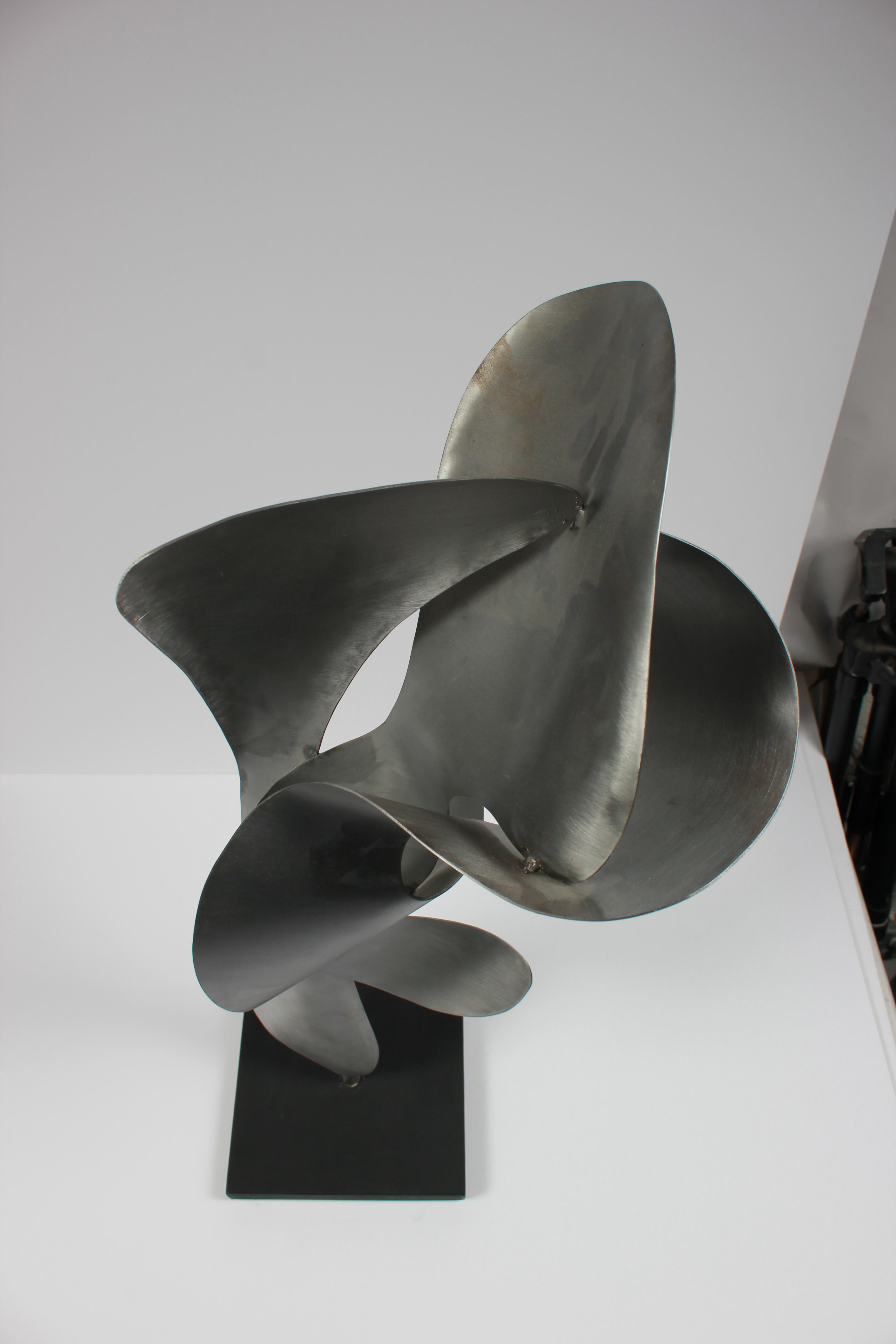 This 2014 aluminum on wood sculpture is signed at the bottom and is entitled Flame #5.  Purchased from a collector and part of a larger body of sculptural work.