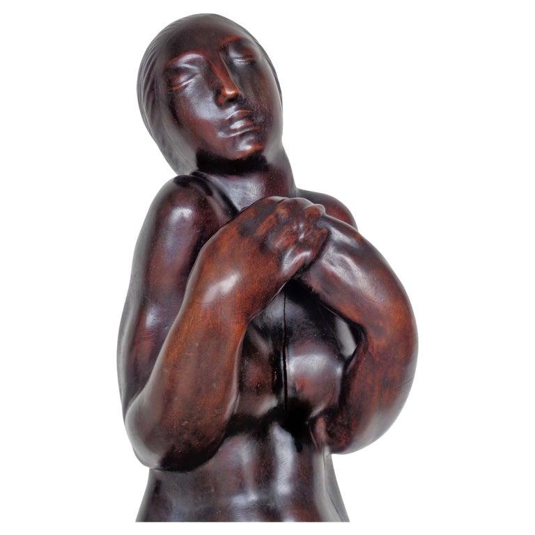Exceptional and expressively carved solid walnut near life Size statue of nude woman raised on attached fluted column pedestal base in overall beautifully aged original rich surface color patina. French Art Deco period, circa 1920s. Please, contact