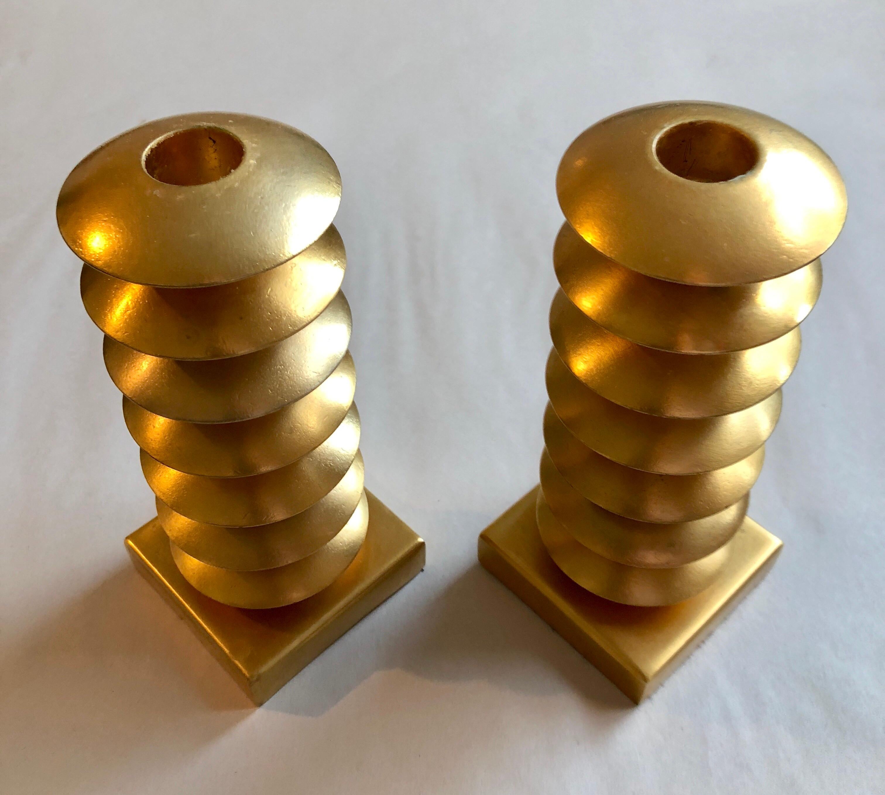 Elegant gold gilt design metal candleholders, circa 1980, France. Signed Illegibly on bottom felt. It appears to be Elizabeth and then something else but it is not clear these candle sticks are possibly designed by Garouste & Bonetti. These would go