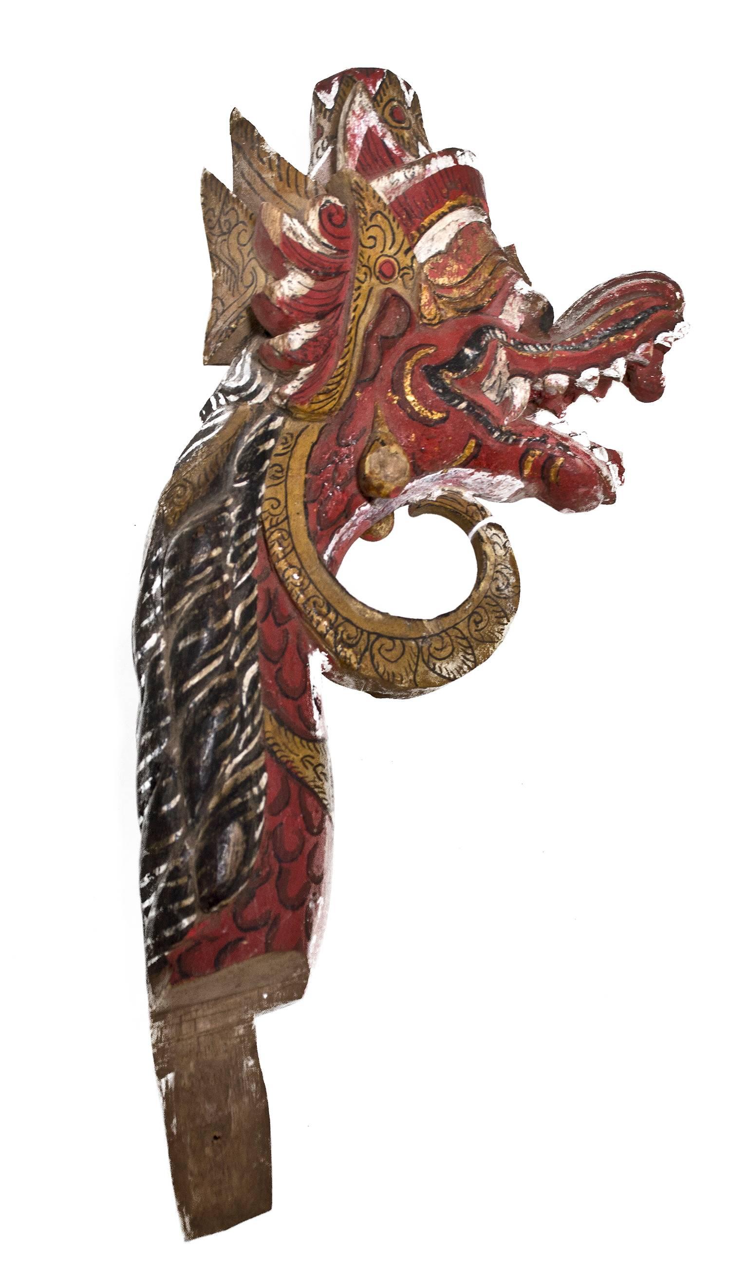 This Garuda finial was created by an unknown Indonesian artist out of wood. A finial or hip-knob is an element marking the top or end of some object, often formed to be a decorative feature. The sculpture is 10 1/2