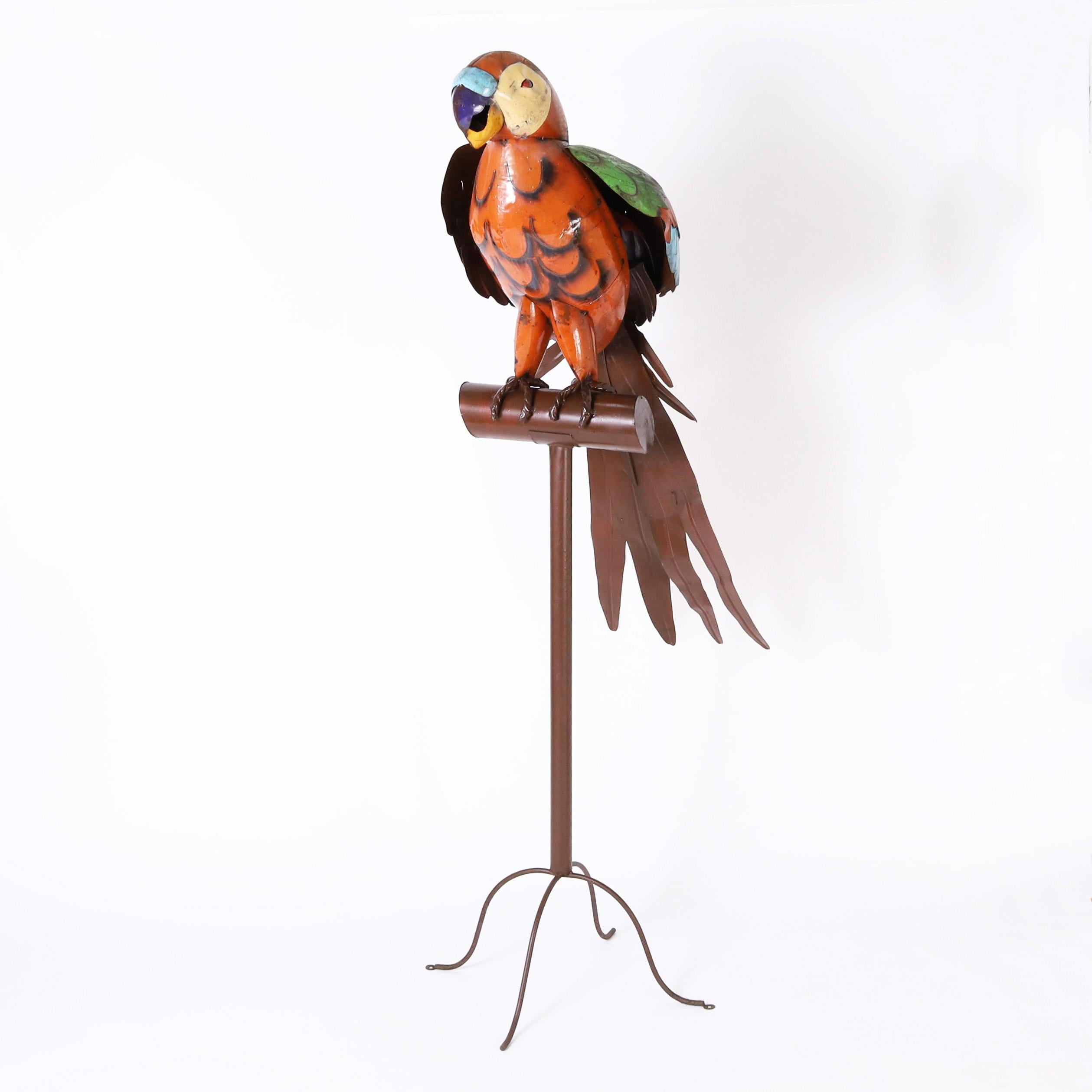 Outrageous vintage giant parrot sculpture hand crafted in metal, paint decorated and permanently perched on a metal stand with four cabriole legs.