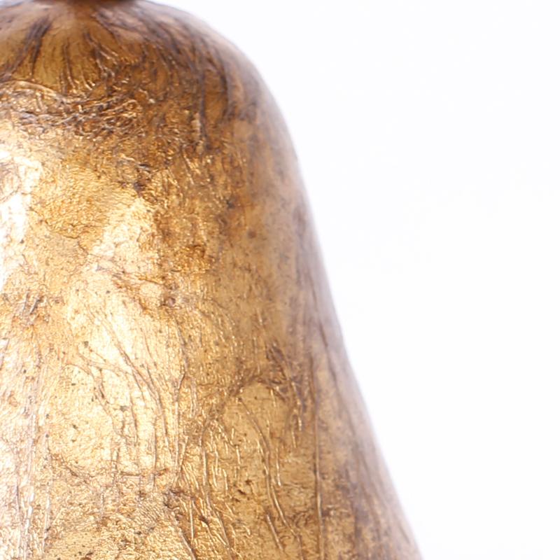 Large sculptural pear crafted in porcelain and decorated with textured gold leaf with metal leaves.